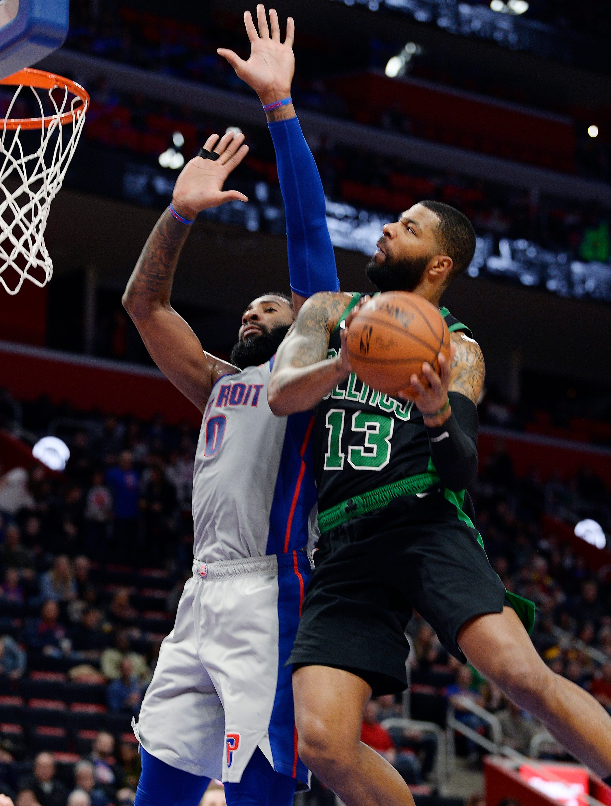 Celtics ' Marcus Morris shoots over Pistons " Andre Drummond in the first quarter.