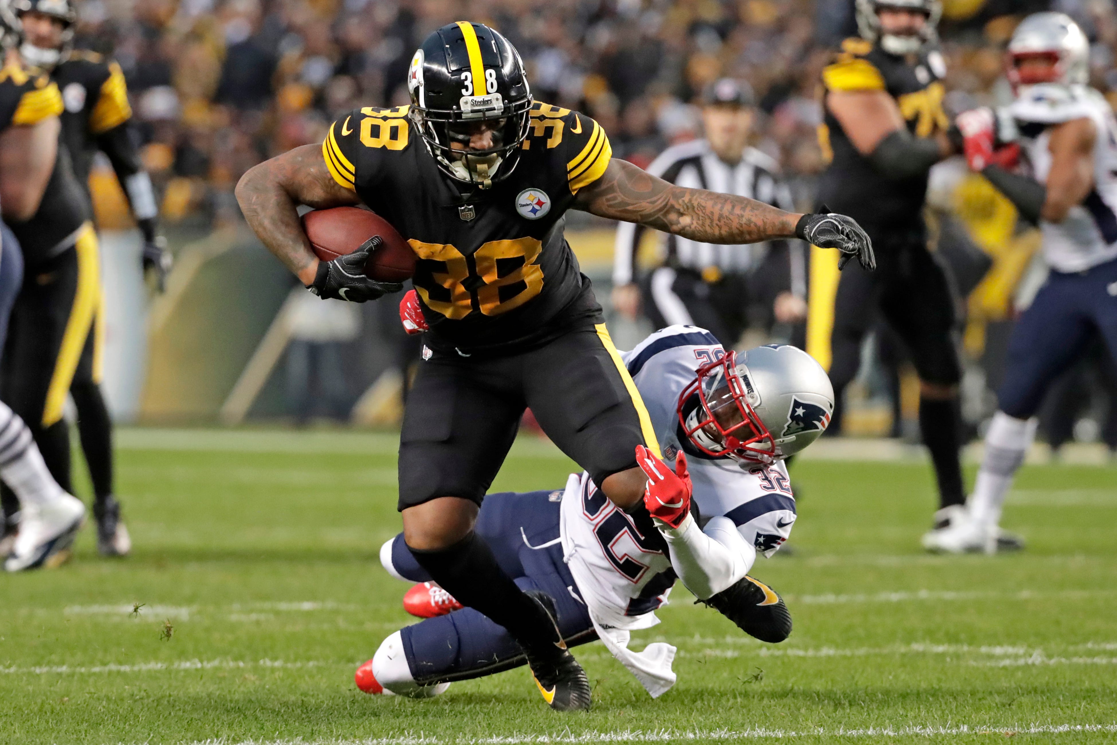 Pittsburgh Steelers running back Jaylen Samuels (38) is tackled by New England Patriots free safety Devin McCourty during the first half on Sunday.