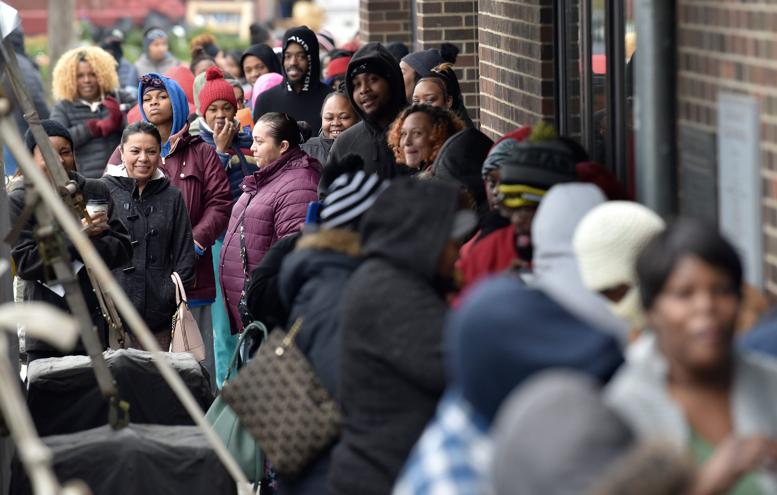 About 500 pre-registered and invited families line up around Eastern Market's Shed 5 as they wait to enter and shop for Christmas presents during the U.S. Marine  CorpsToys for Tots program, Thursday, Dec. 20, 2018. Gifts are donated by Detroit Pistons owner Tom Gores and his wife, Holly.