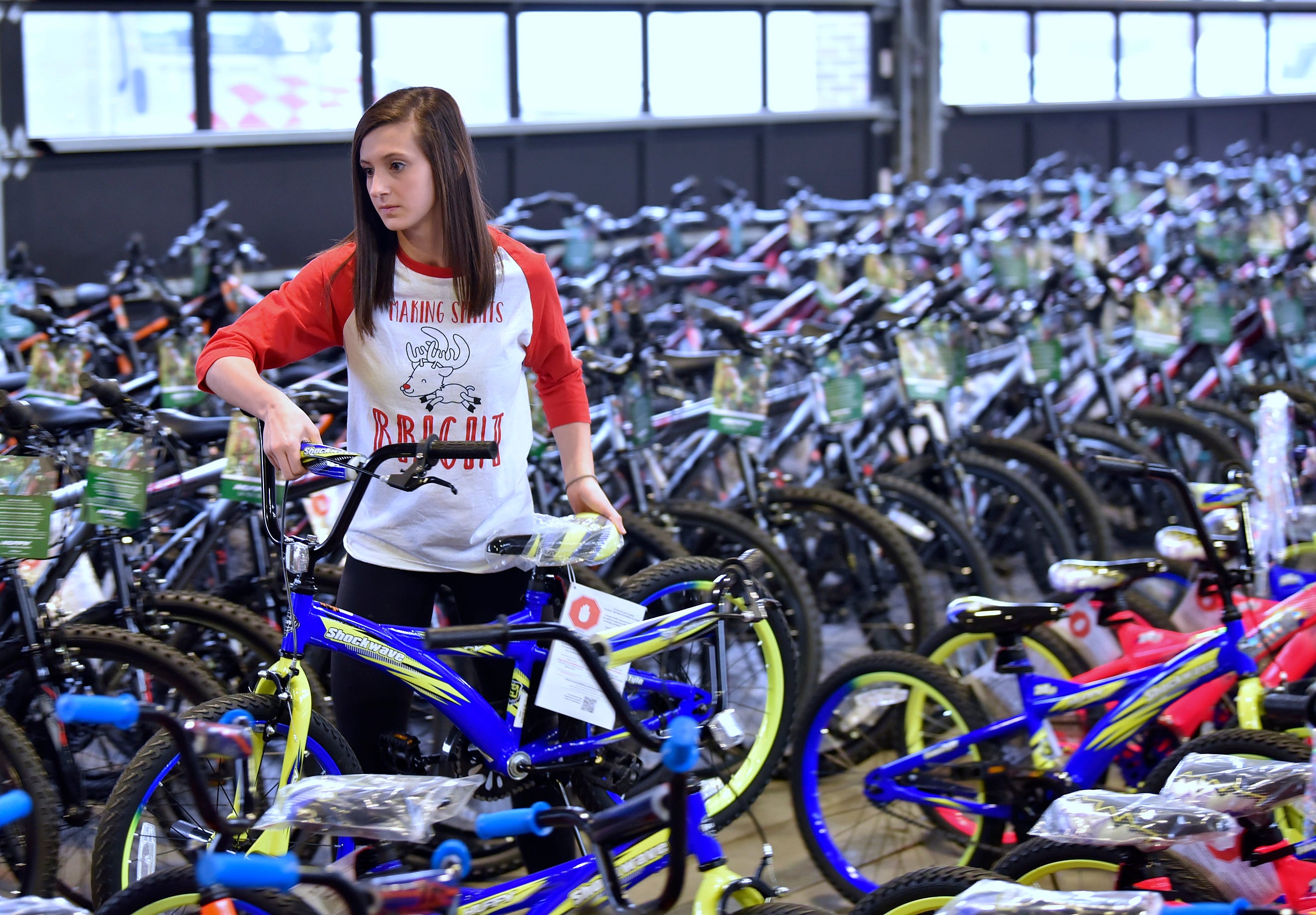 Shelby Township Eisenhower High School student council member and senior Julianna Belanger, 17, of Shelby Township retrieves a bicycle for a family.