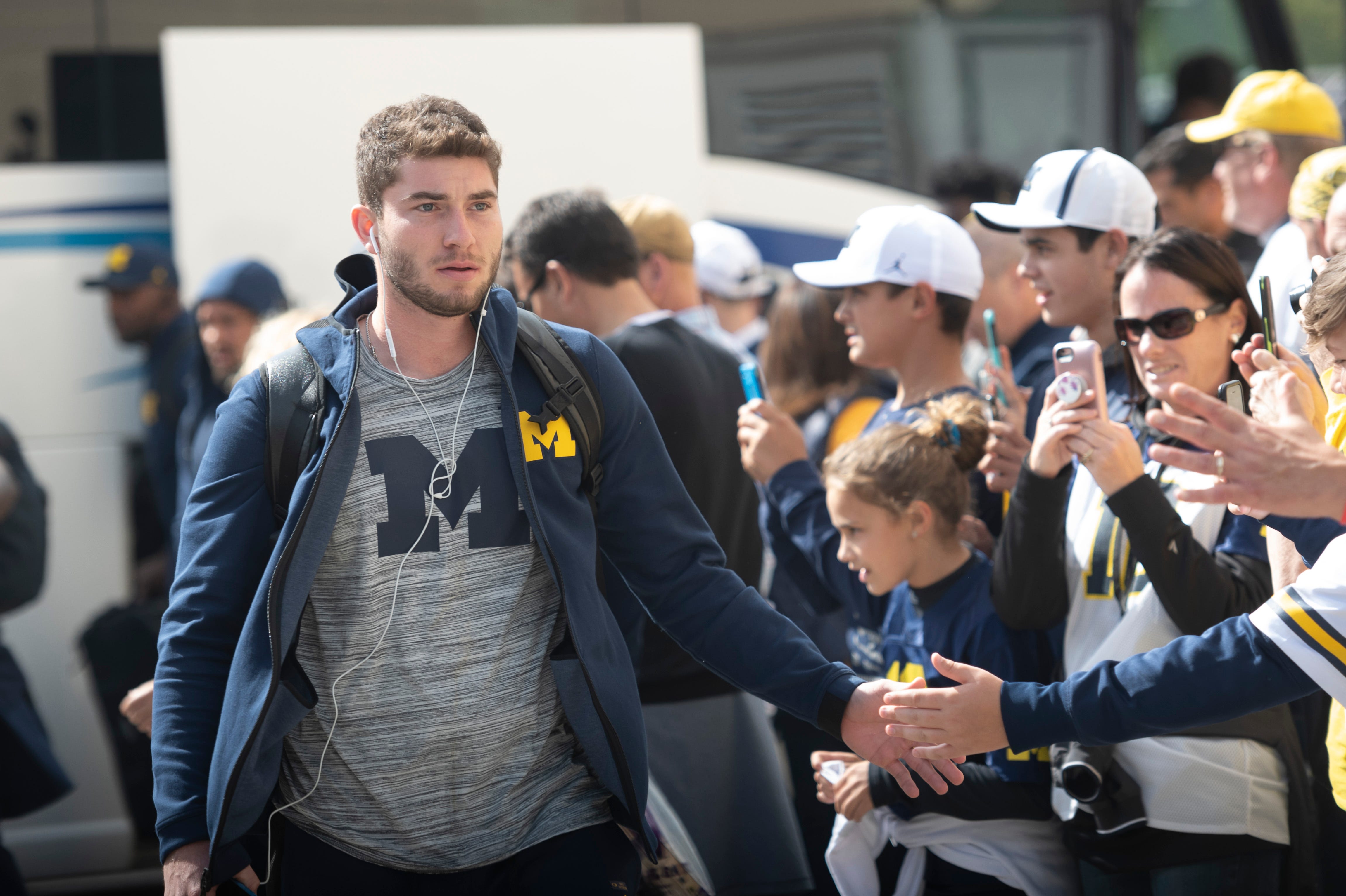 Michigan quarterback Shea Patterson arrives at Ryan Field with the team before the game against Northwestern.
