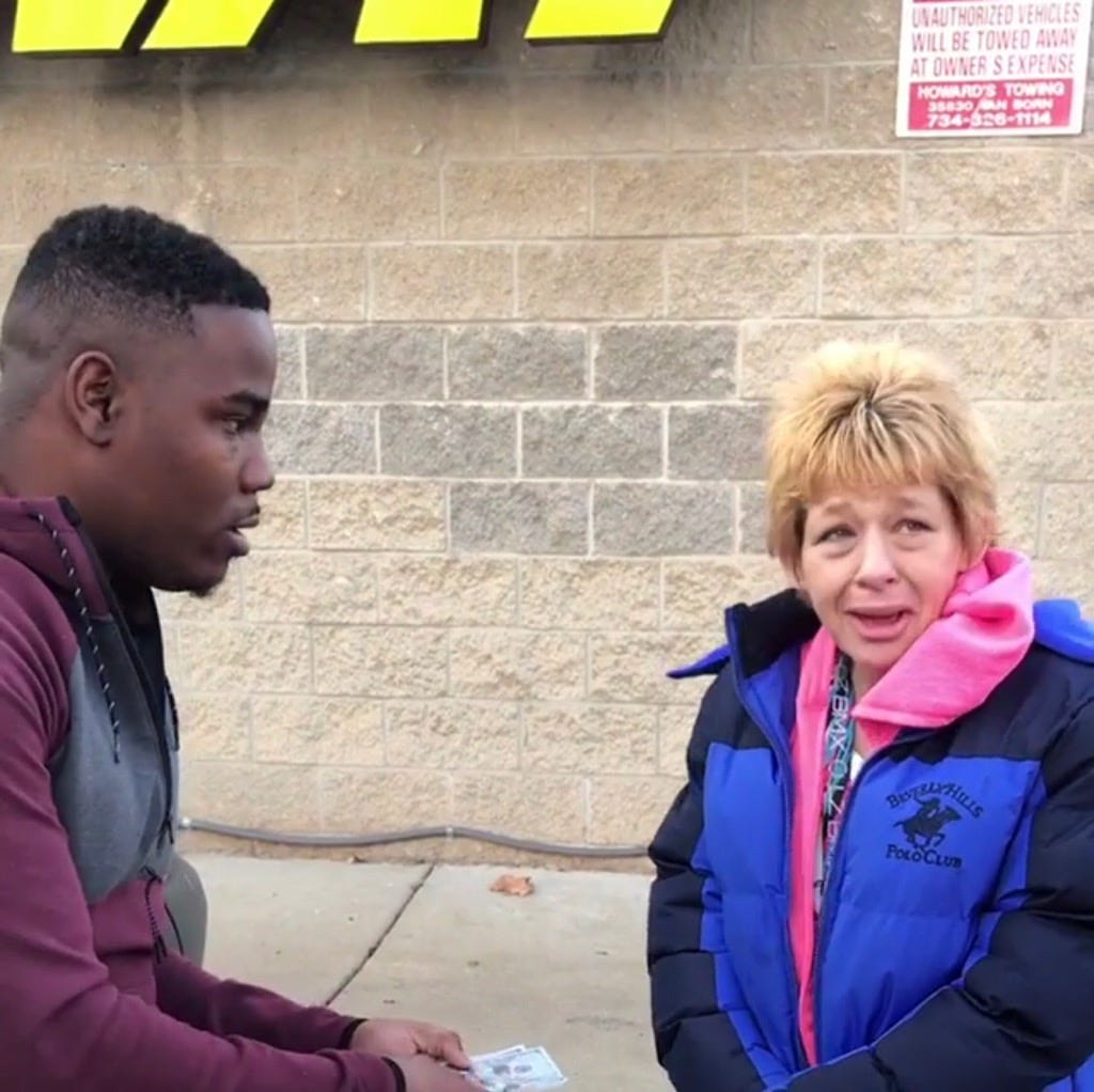 Detroit comedian HaHa Davis, left, gives money to an unnamed woman in need in this viral video which was shown Friday on the syndicated talk show 'The Real.'