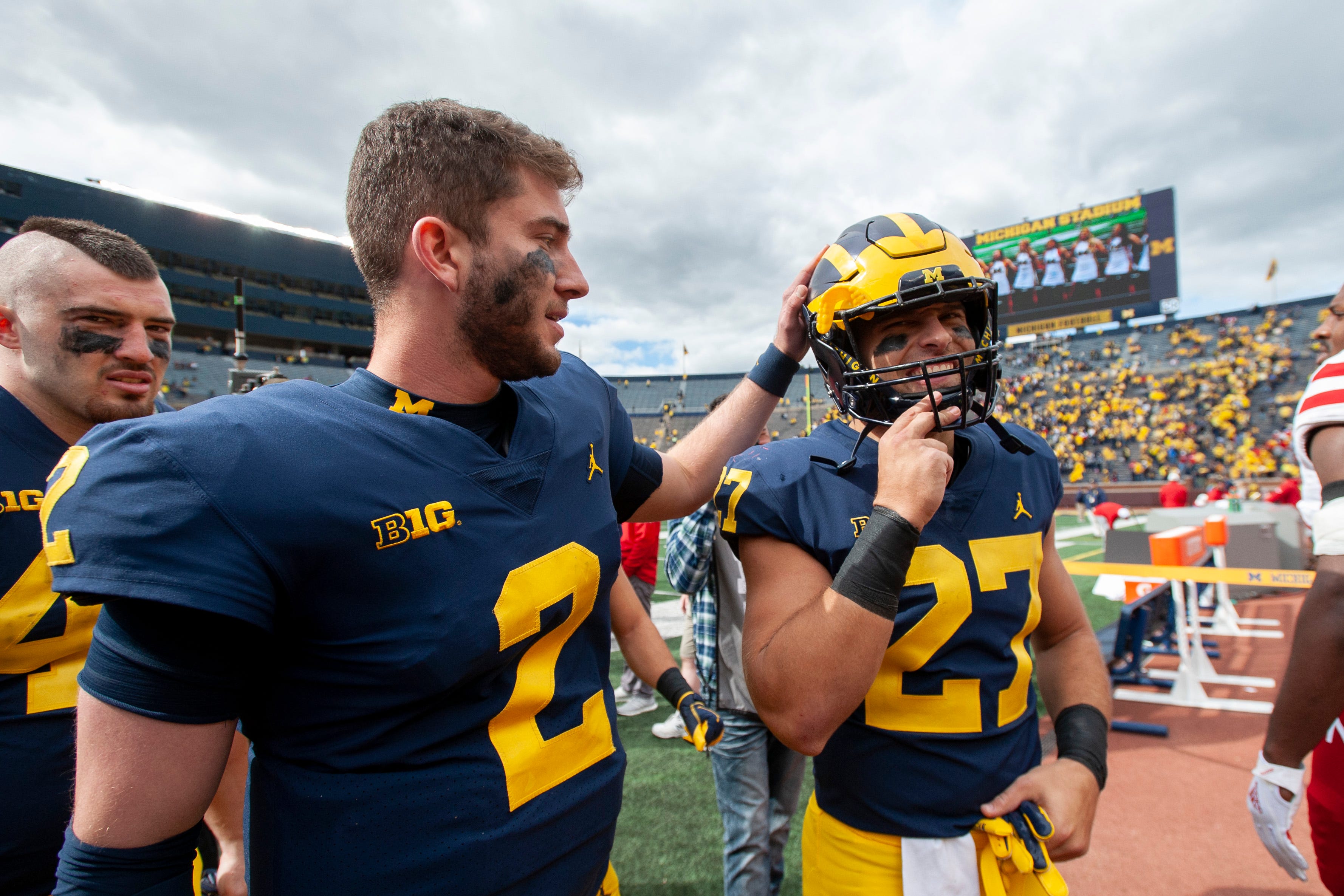 Michigan quarterback Shea Patterson, left, and running back Joe Hewlett walk off the field together after the game against Nebraska.
