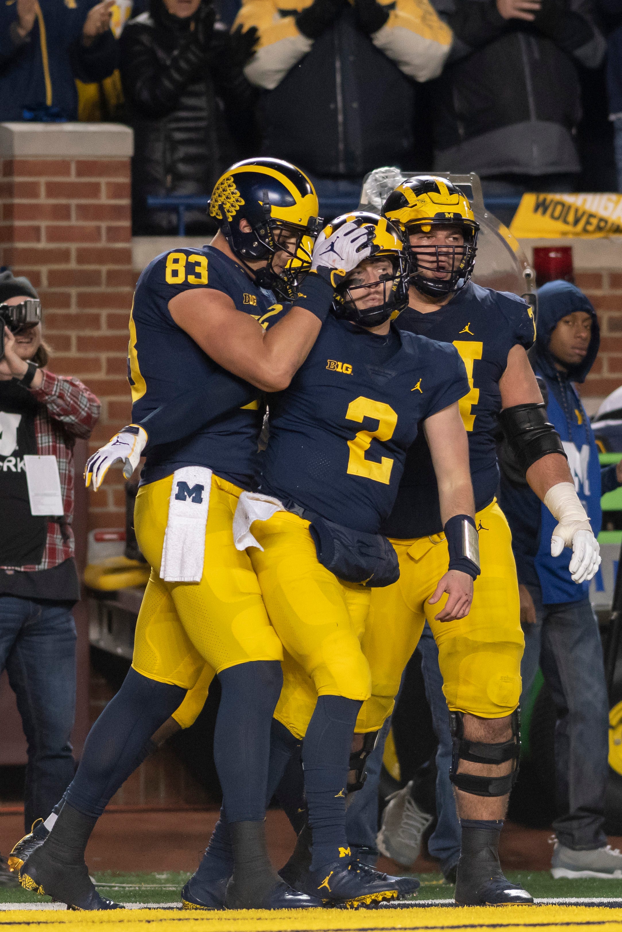 Michigan tight end Zach Gentry, quarterback Shea Patterson and offensive lineman Ben Bredeson celebrate after Patterson ran for a touchdown in the third quarter against Wisconsin.