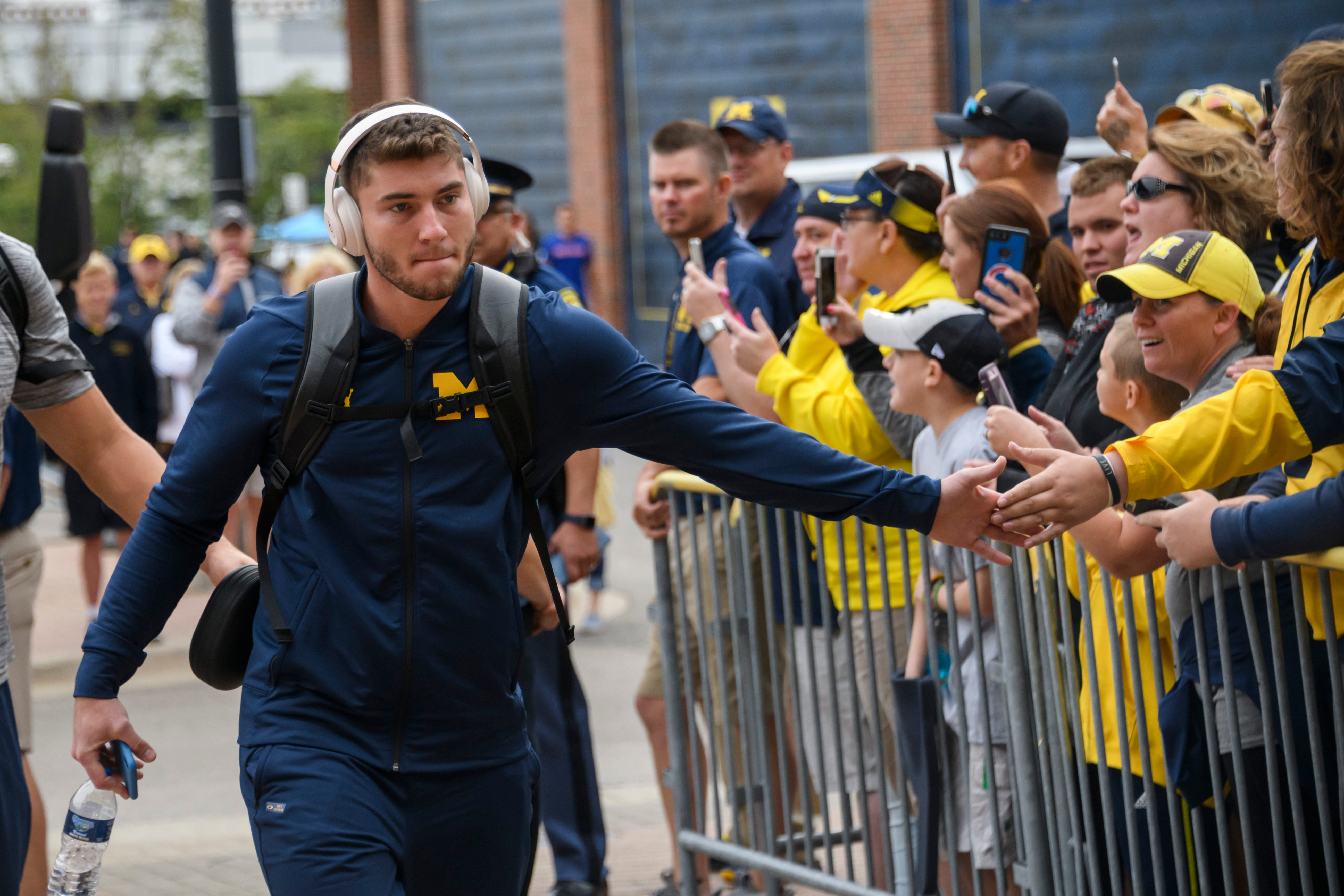 Michigan quarterback Shea Patterson greets fans as the team arrives at Michigan Stadium for the game against Western Michigan.