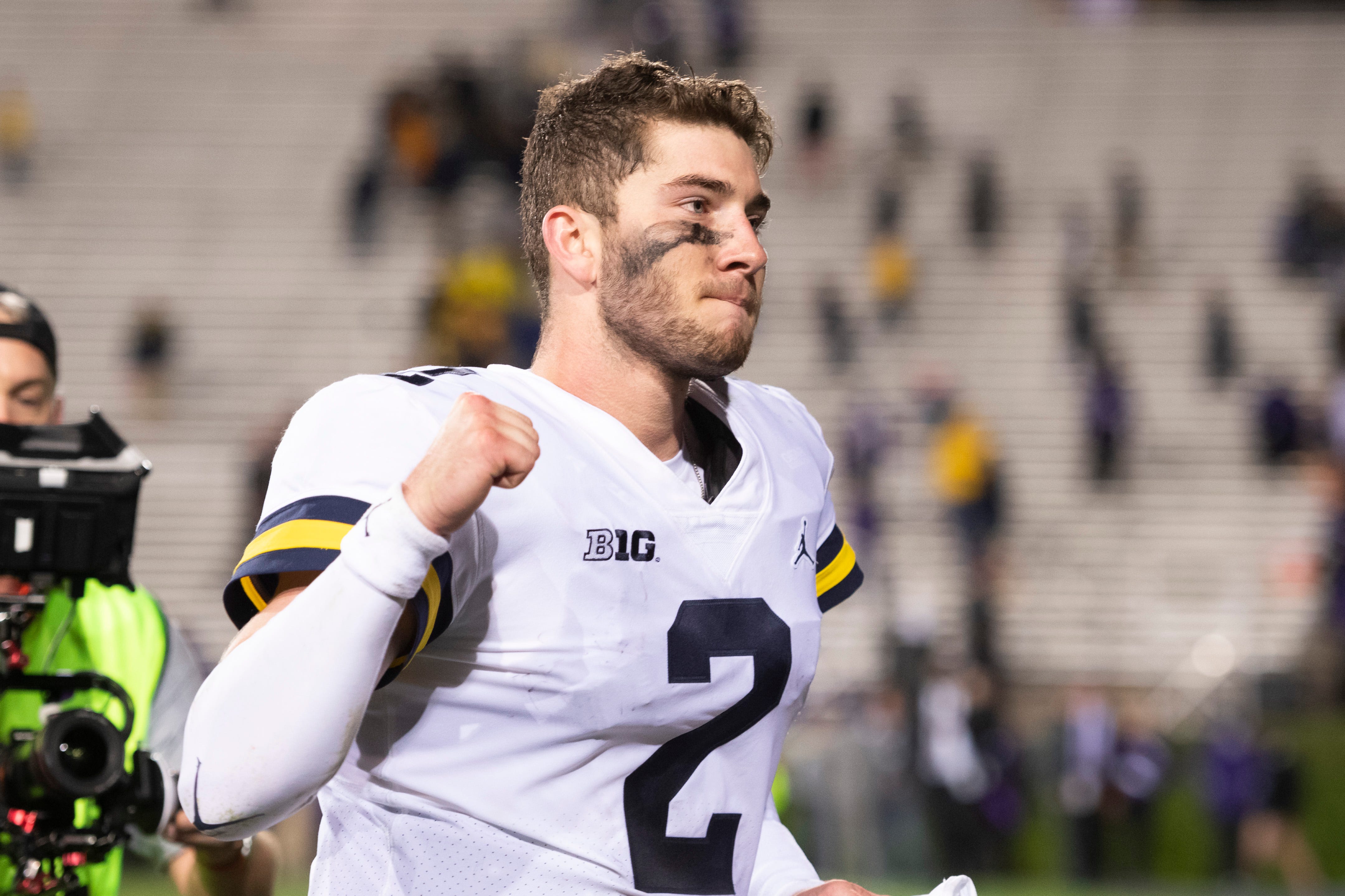 Michigan quarterback Shea Patterson pumps his fists at the fans after the game against Northwestern.