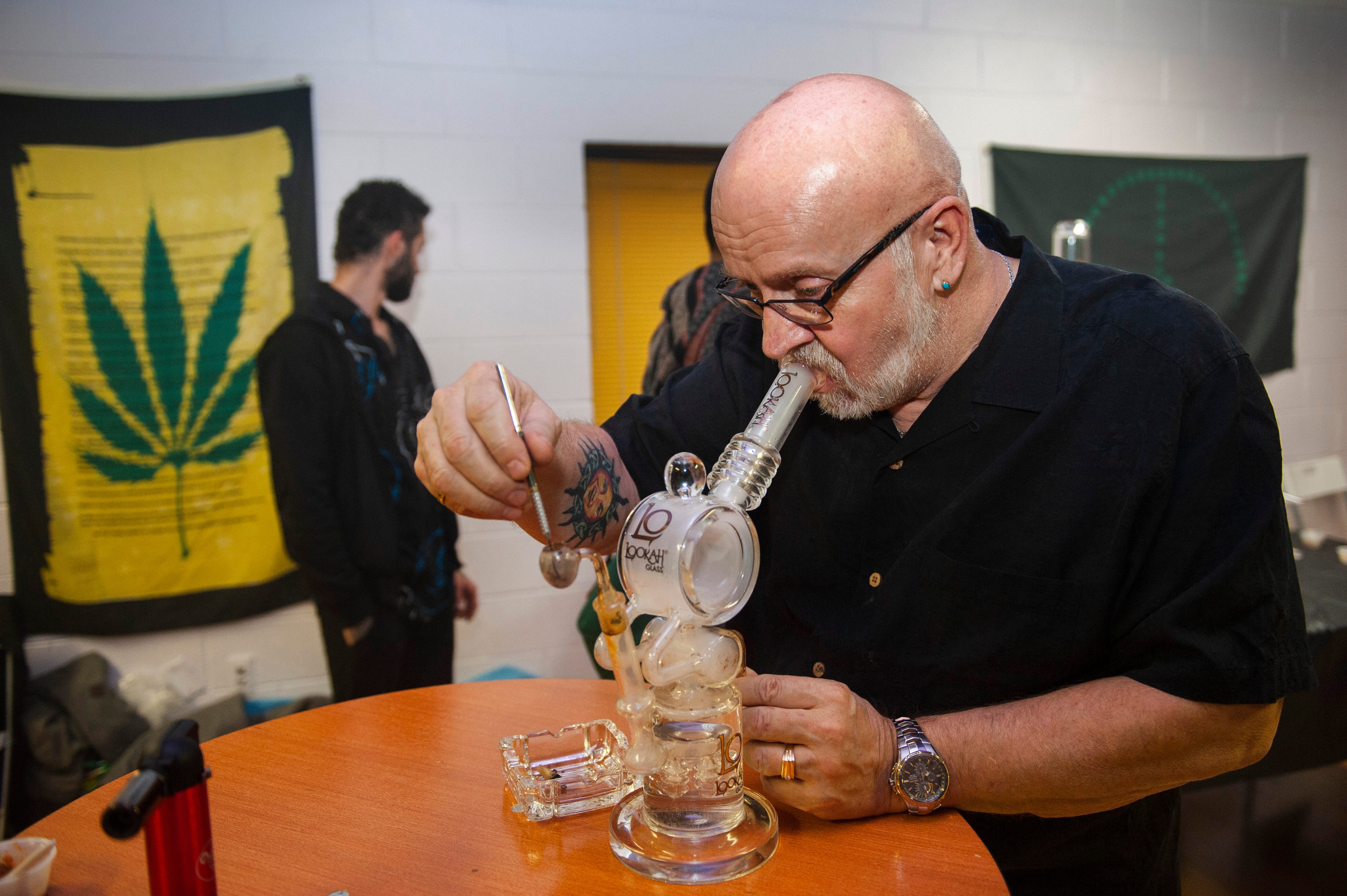 Don Short, 61, of Holland, Michigan, a medical marijuana card-holder and longtime marijuana user, smokes a condensed form of THC called "shatter" from a glass bong. Short's daughter, Erin Short, was the featured artist at "The Art of Cannabis" exhibition and tasting event at the Cannabis Counsel in Detroit. Erin Short's CCS senior thesis project explored the lives of Michigan medical marijuana patients and their preferred methods of using cannabis.