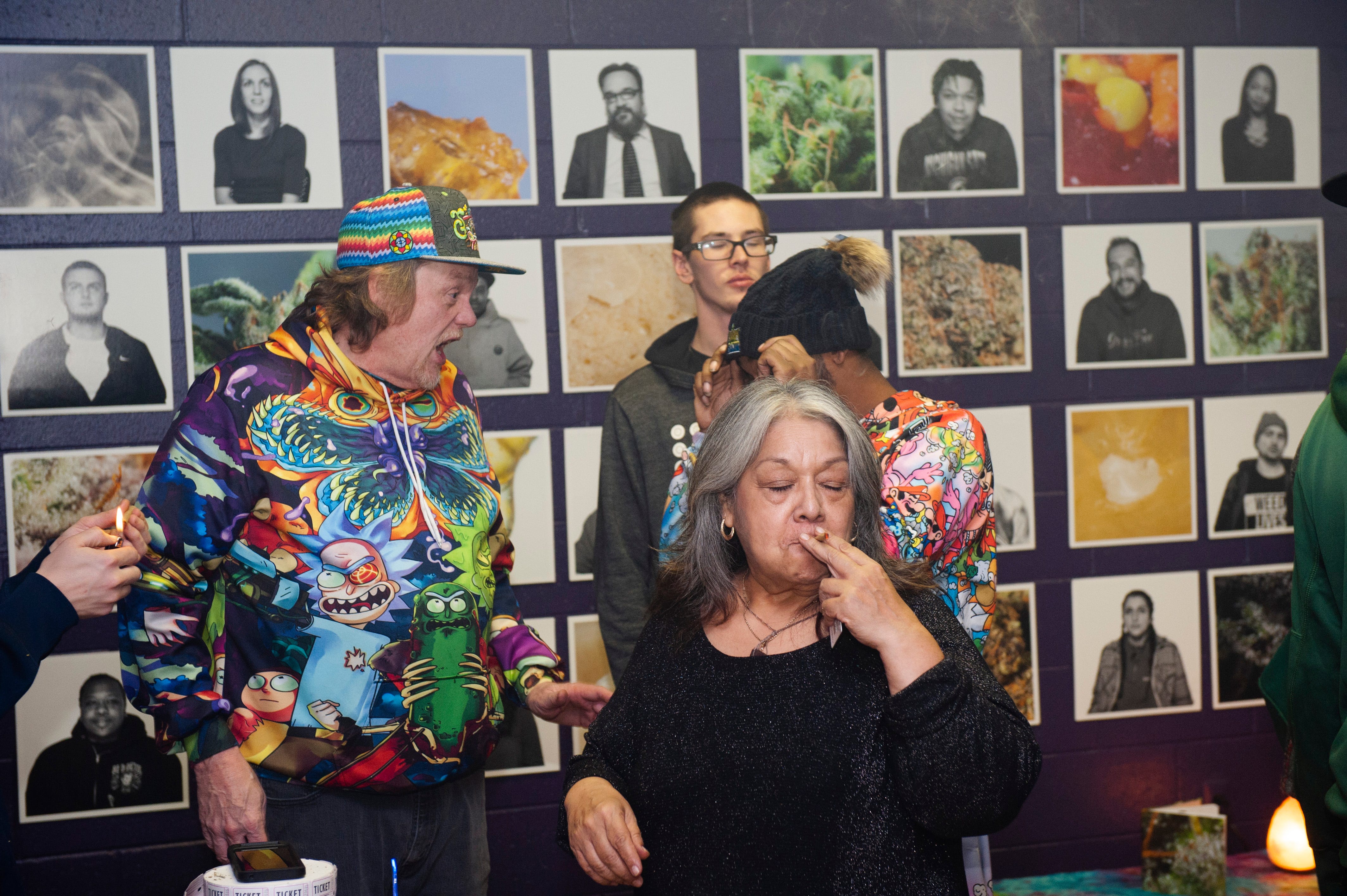 Joanne Diaz, 65, of Flint takes a hit during "The Art of Cannabis" event at the Cannabis Counsel in Detroit on Saturday, Dec. 22, 2018. Diaz said she's smoked marijuana since she was 15 years old.