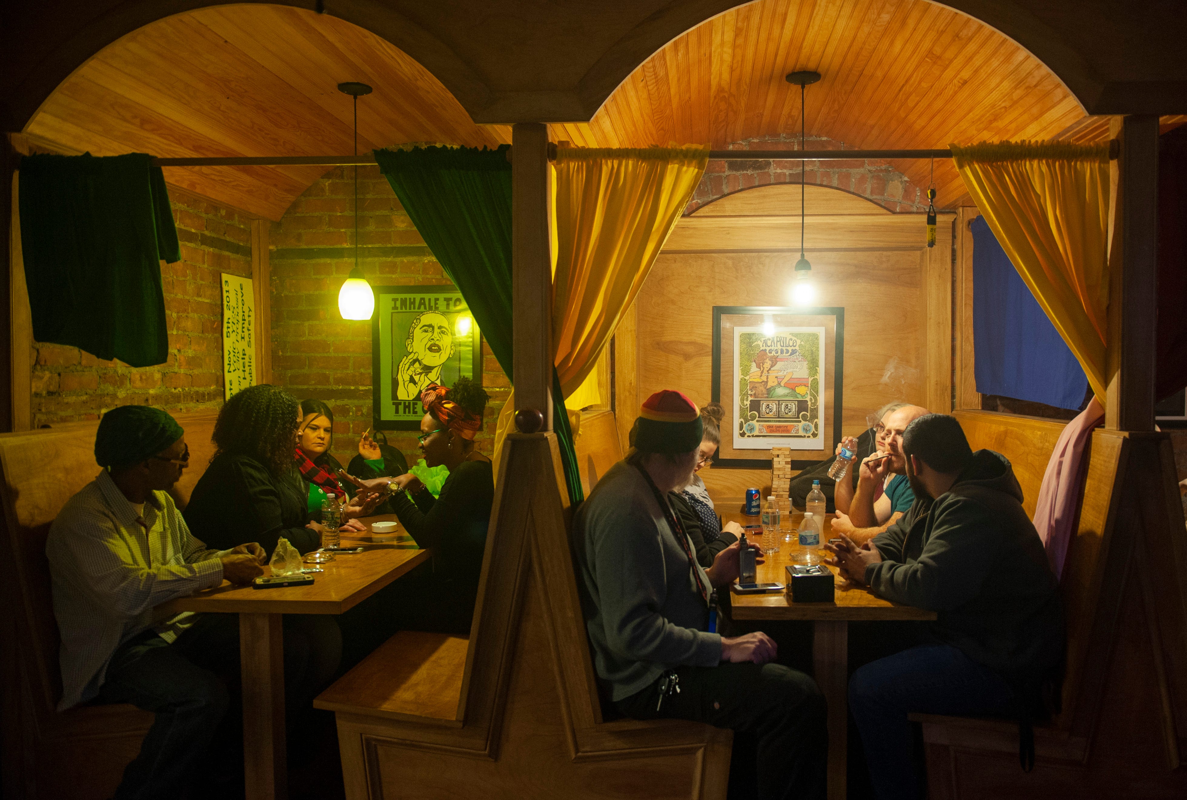 Guests at "The Art of Cannabis" event at the Cannabis Counsel in Detroit hang out in restaurant-style booths smoking marijuana and waiting for the festivities to begin on Saturday, Dec. 22, 2018.
