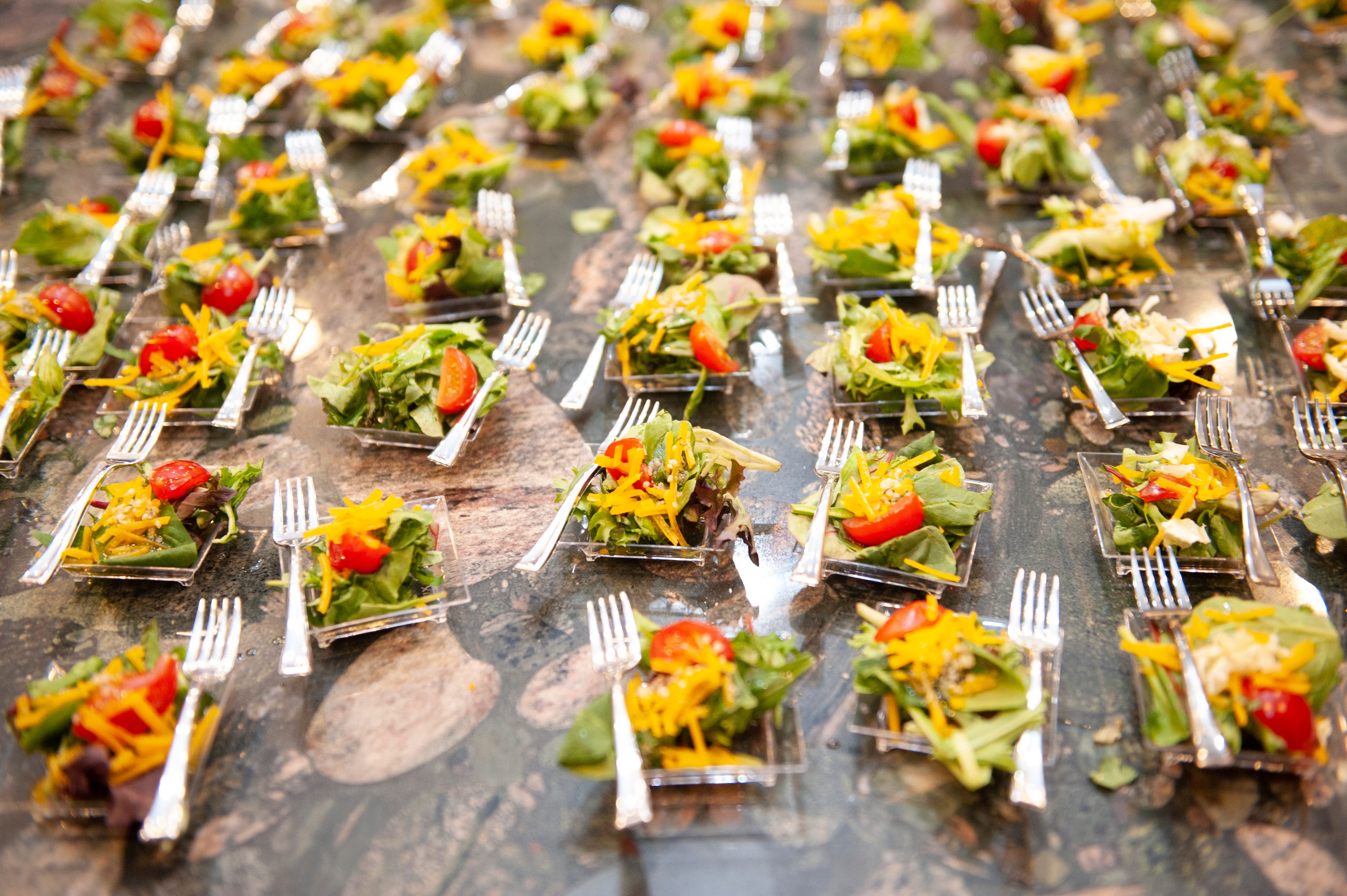 Cannabis-infused salad appetizers by Chef Gigi Diaz are displayed as free samples for guests to enjoy.