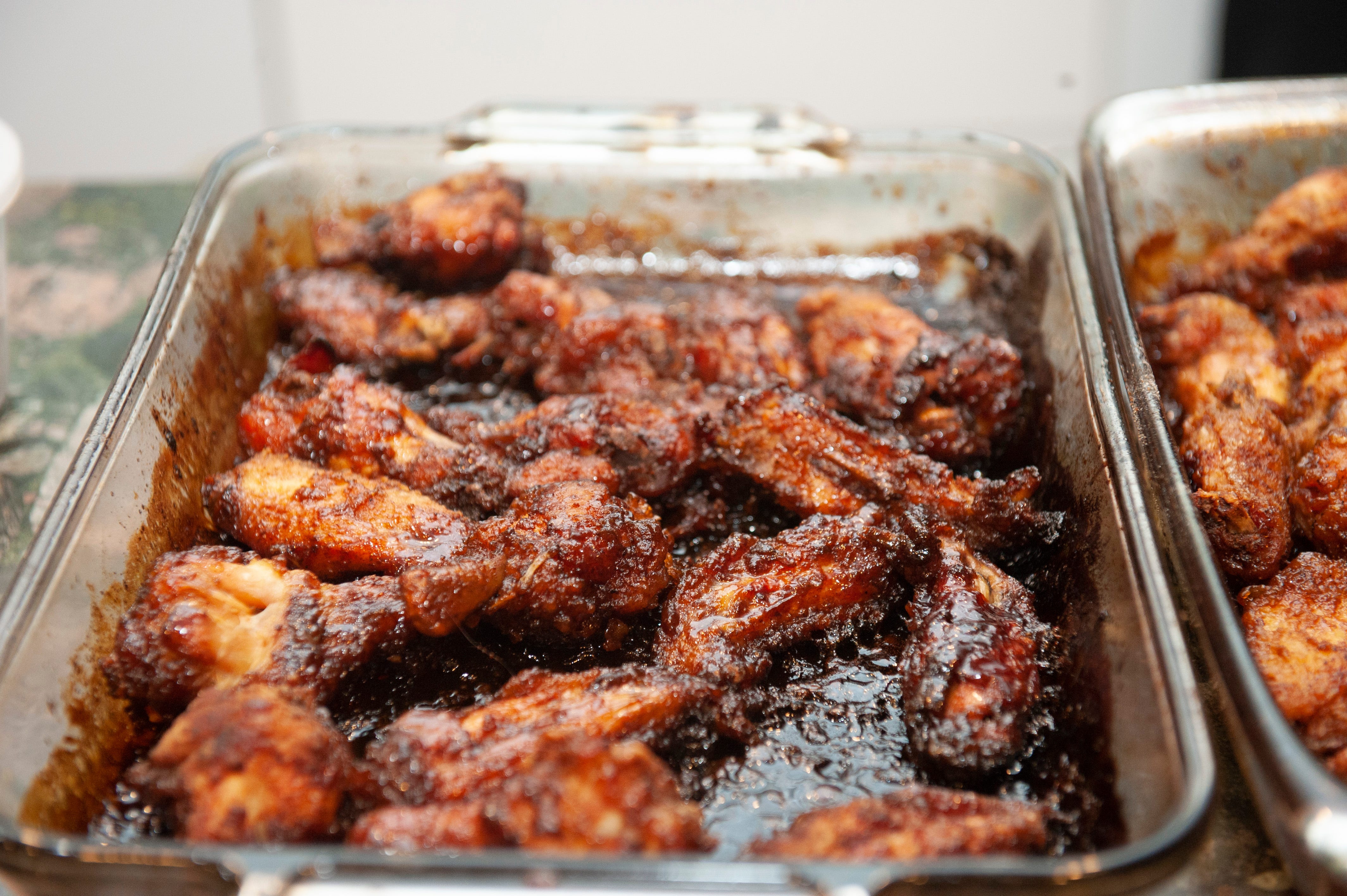Cannabis-infused Kush Cola chicken wings by Cannabis Concepts chef Gigi Diaz arrive hot out of the oven for party guests to sample during "The Art of Cannabis" tasting and art exhibition.