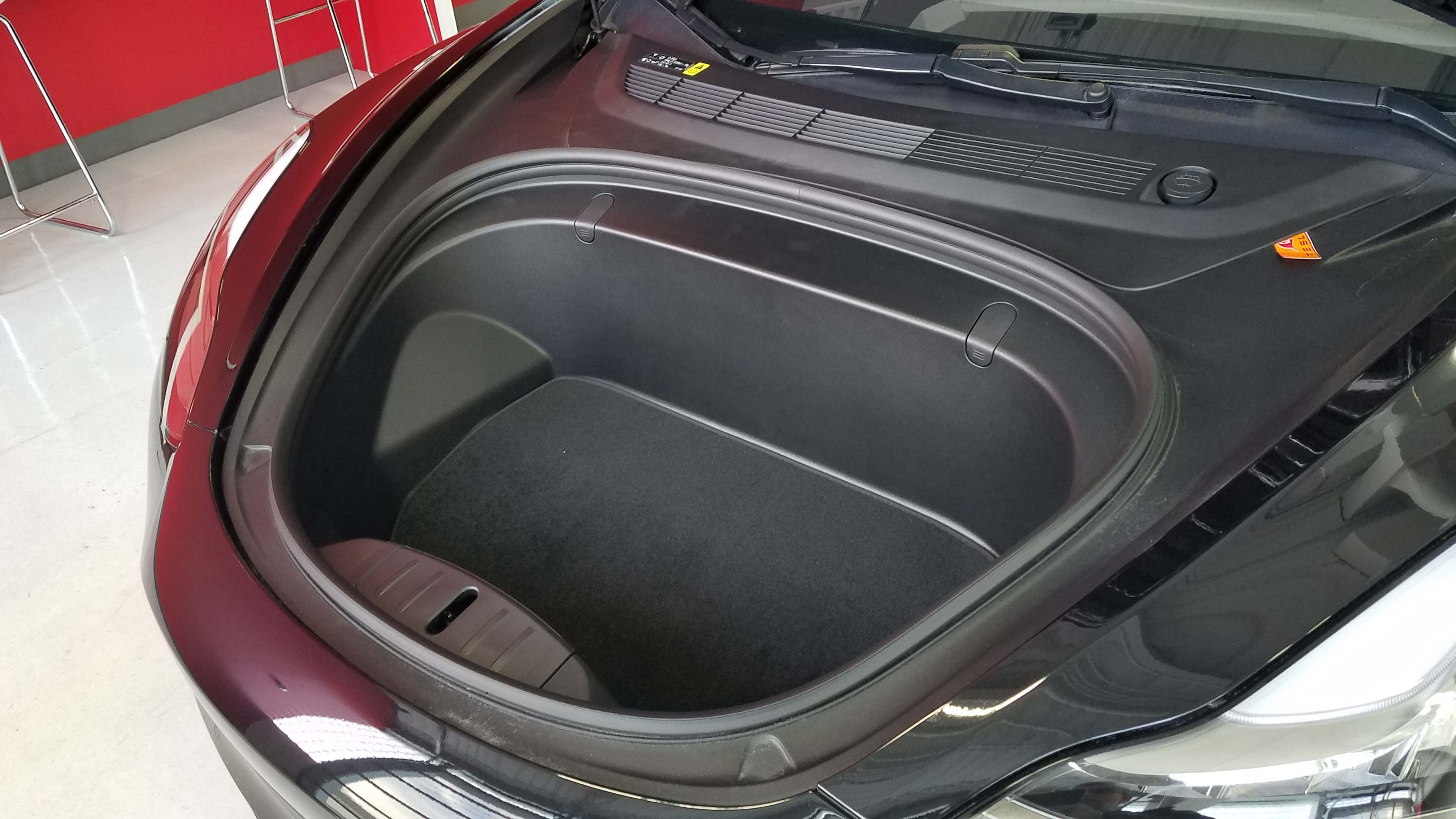 Without an engine in front, the electric Tesla Model 3 features a "frunk" for added storage.