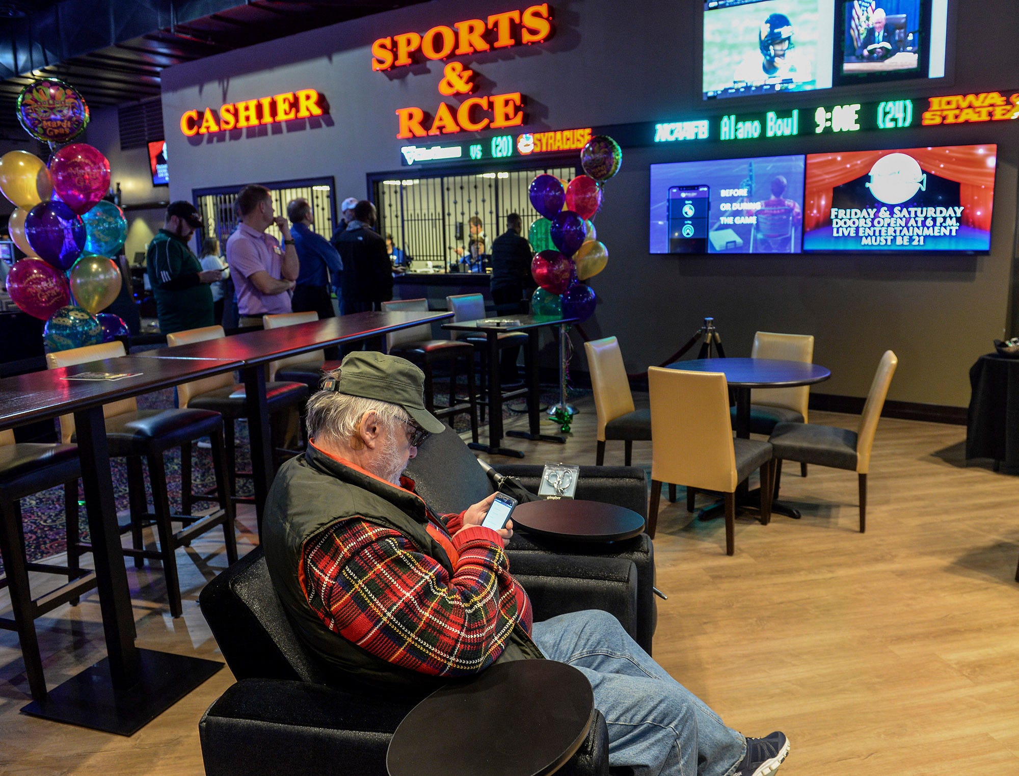 Tom Baldwin of Paint Creek, W.V., tries to download the new online sports betting application onto his smart phone soon after the official ribbon cutting opening of the sportsbook betting app at Mardi Gras Casino & Resort in Crosslanes, W.V. Friday Dec. 28, 2018.