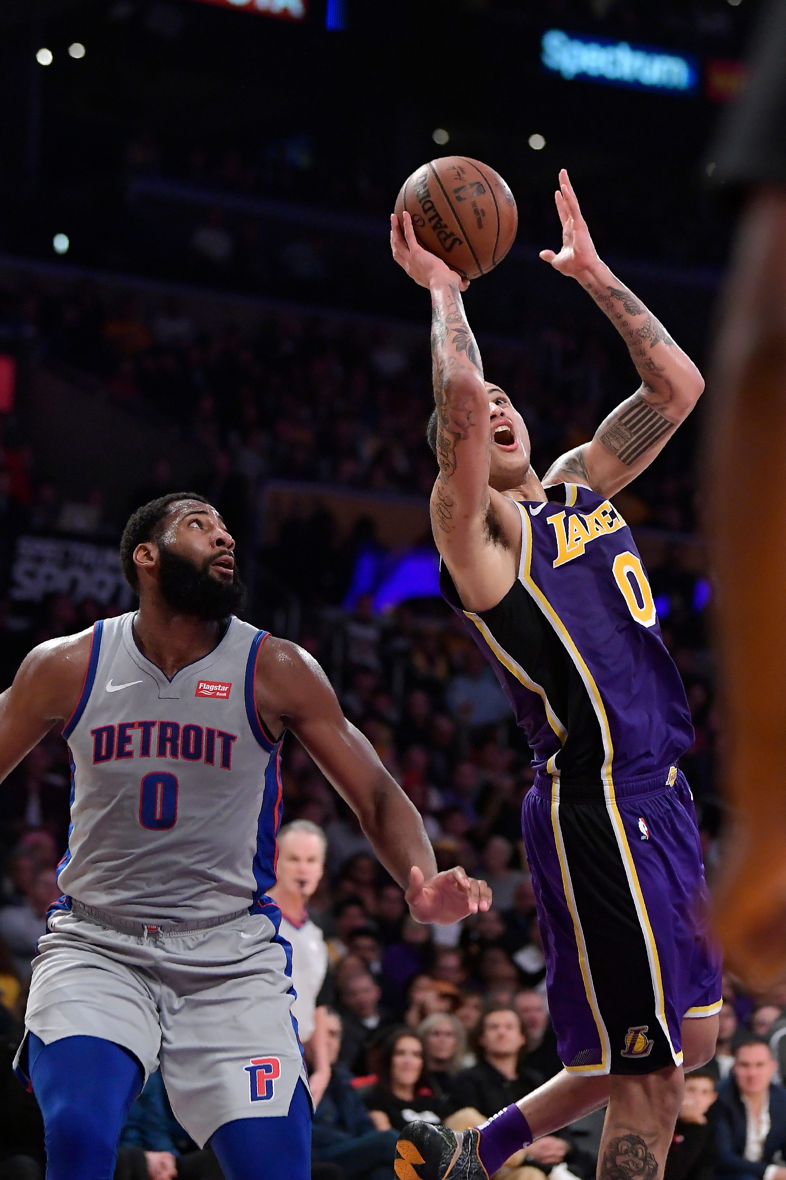 Los Angeles Lakers forward Kyle Kuzma, right, shoots as Detroit Pistons center Andre Drummond defends during the second half.