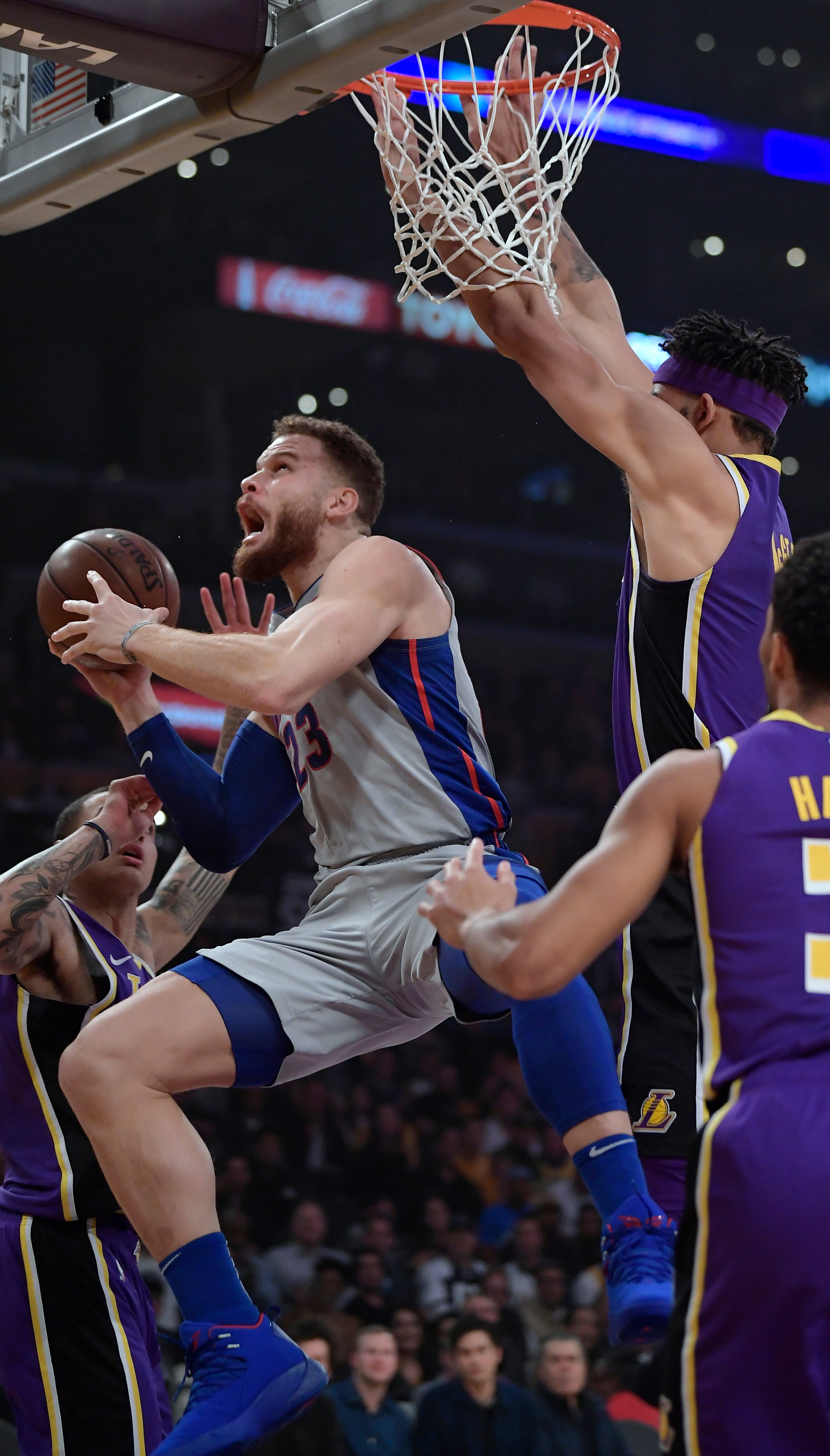 Detroit Pistons forward Blake Griffin, second from left, prepares to shoot as Los Angeles Lakers forward Kyle Kuzma, left, and center JaVale McGee, second from right, defend during the first half.