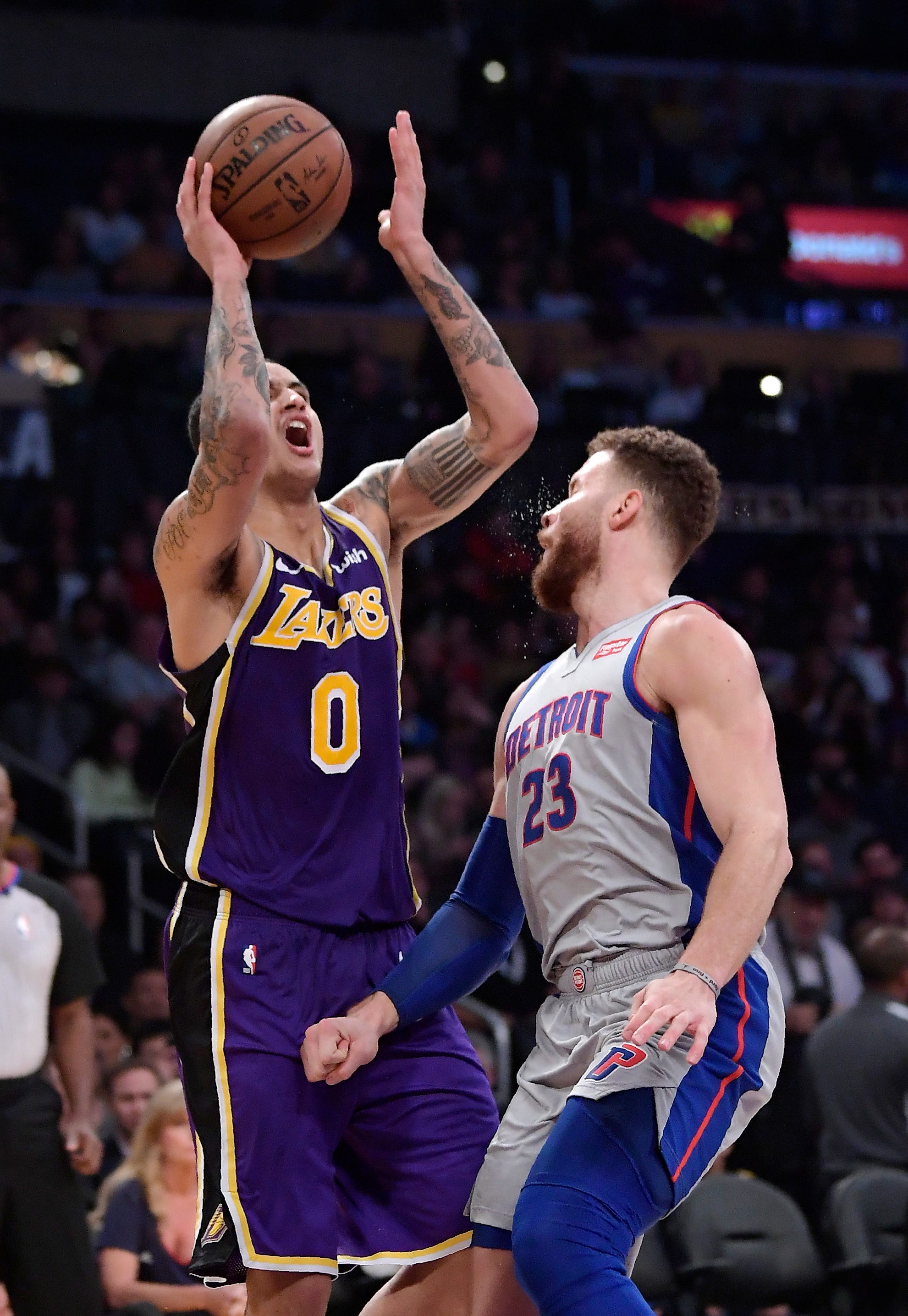 Los Angeles Lakers forward Kyle Kuzma, left, shoots as Detroit Pistons forward Blake Griffin defends during the second half.