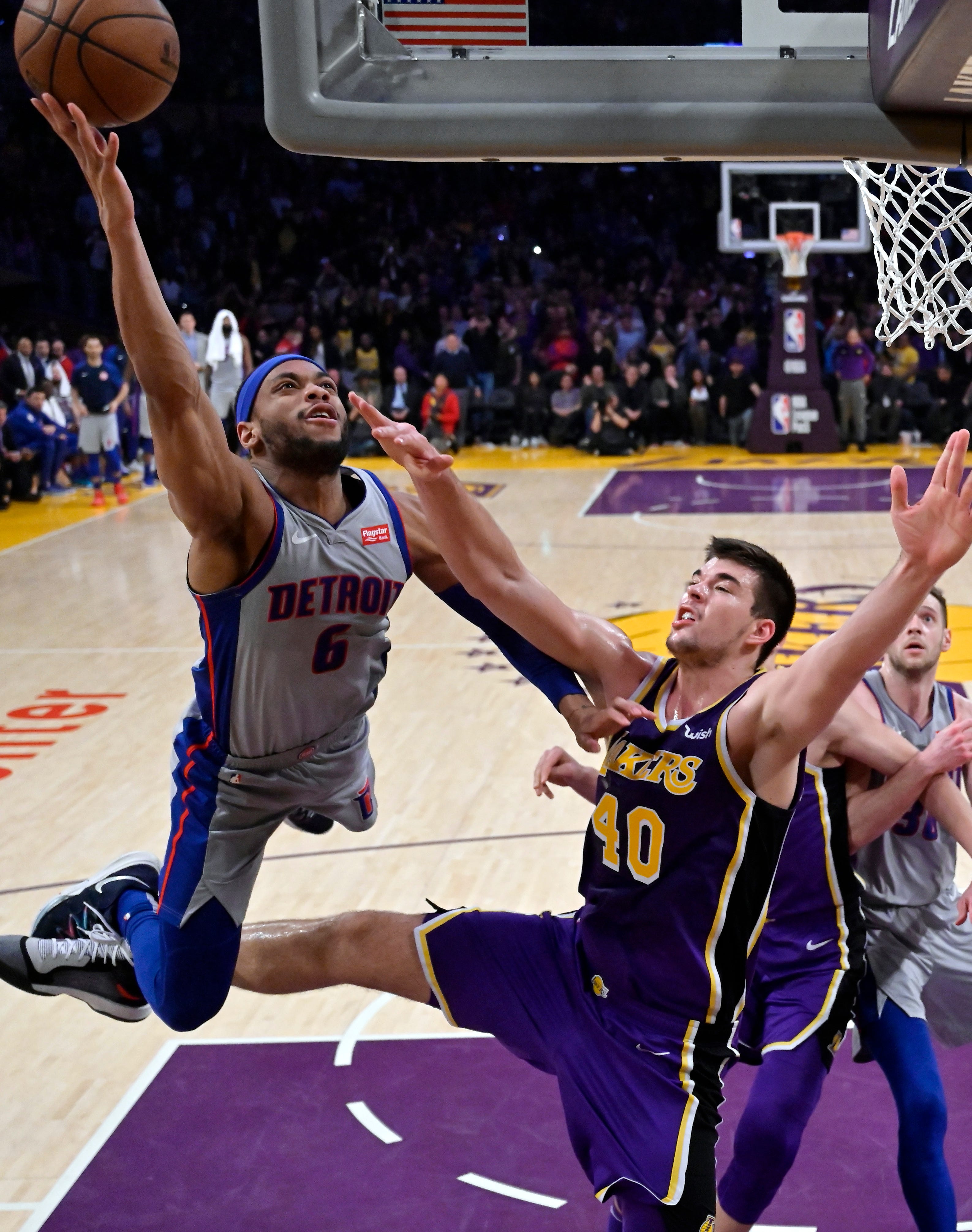 Detroit Pistons guard Bruce Brown, left, shoots as Los Angeles Lakers center Ivica Zubac defends during the second half.