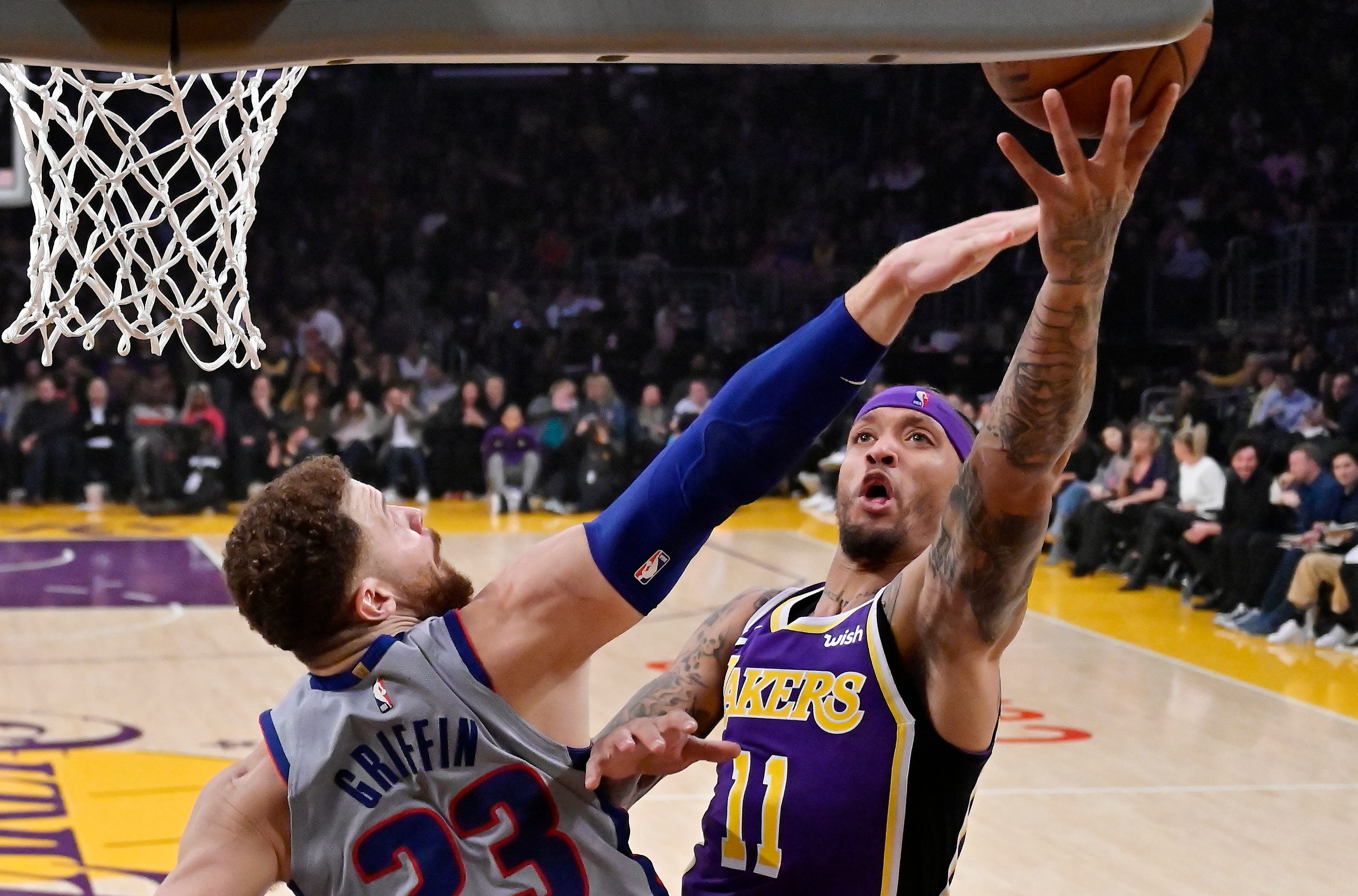 Los Angeles Lakers forward Michael Beasley, right, shoots as Detroit Pistons forward Blake Griffin defends during the first half.