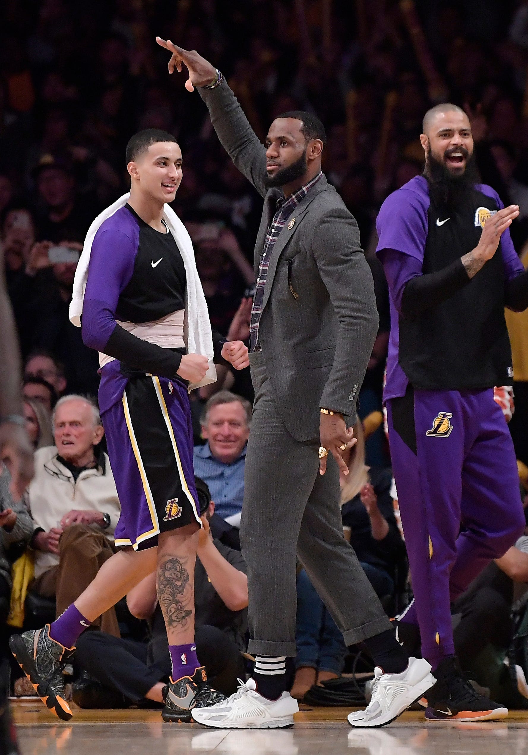 Los Angeles Lakers forward LeBron James, center, celebrates along with forward Kyle Kuzma, left, and center Tyson Chandler after the Lakers scored during the second half.