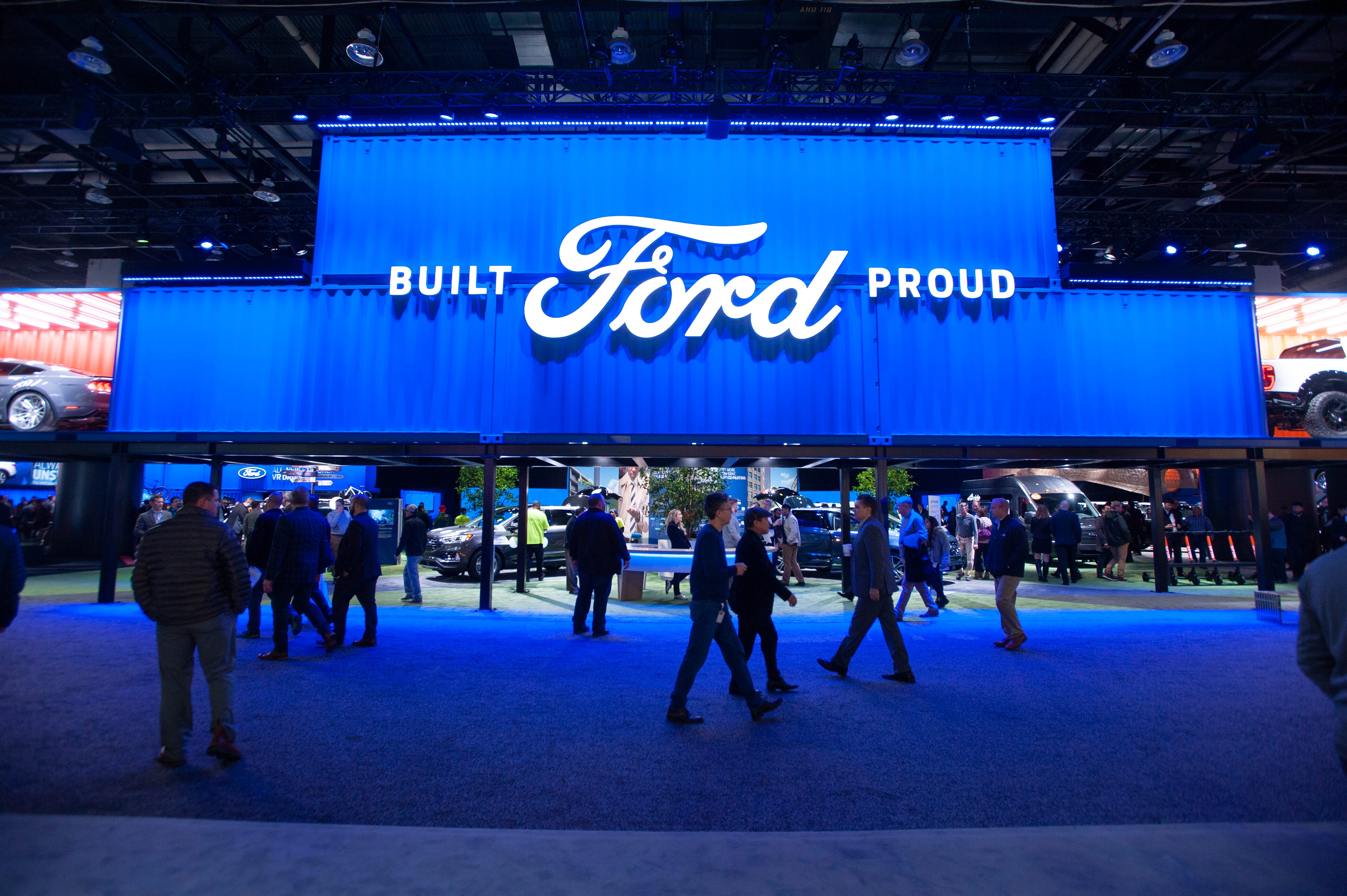 People check out the vehicles and other attractions in the Ford Motor Company exhibit space at the North American International Auto Show at Cobo Center. The company said Wednesday that profit-sharing checks would go out March 14. The amount is based on North American earnings, which was $7.6 billion before interest and taxes in 2018.