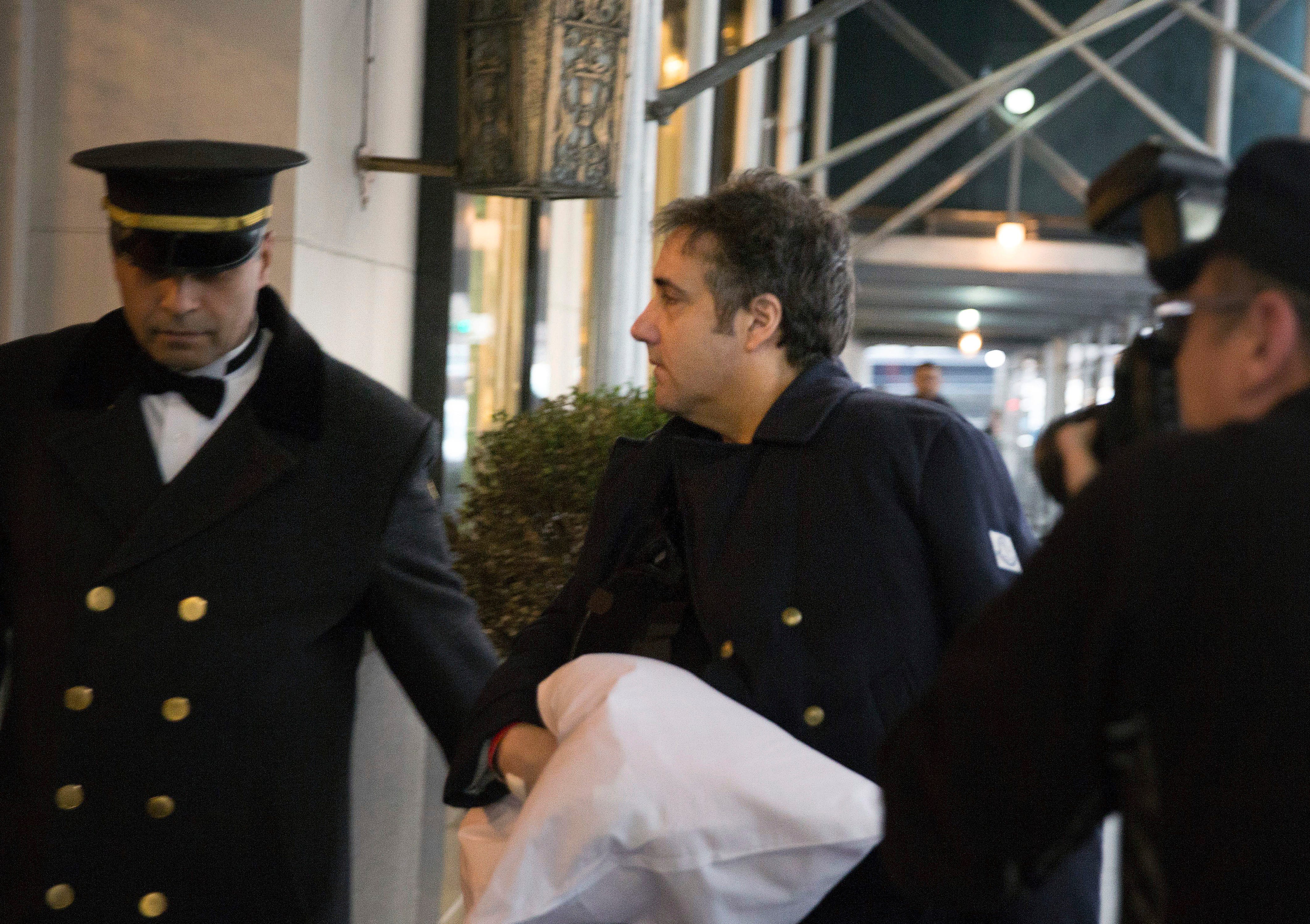 Michael Cohen arrives at his home in New York with his left arm in a sling supported by a pillow Friday, Jan. 18, 2019.