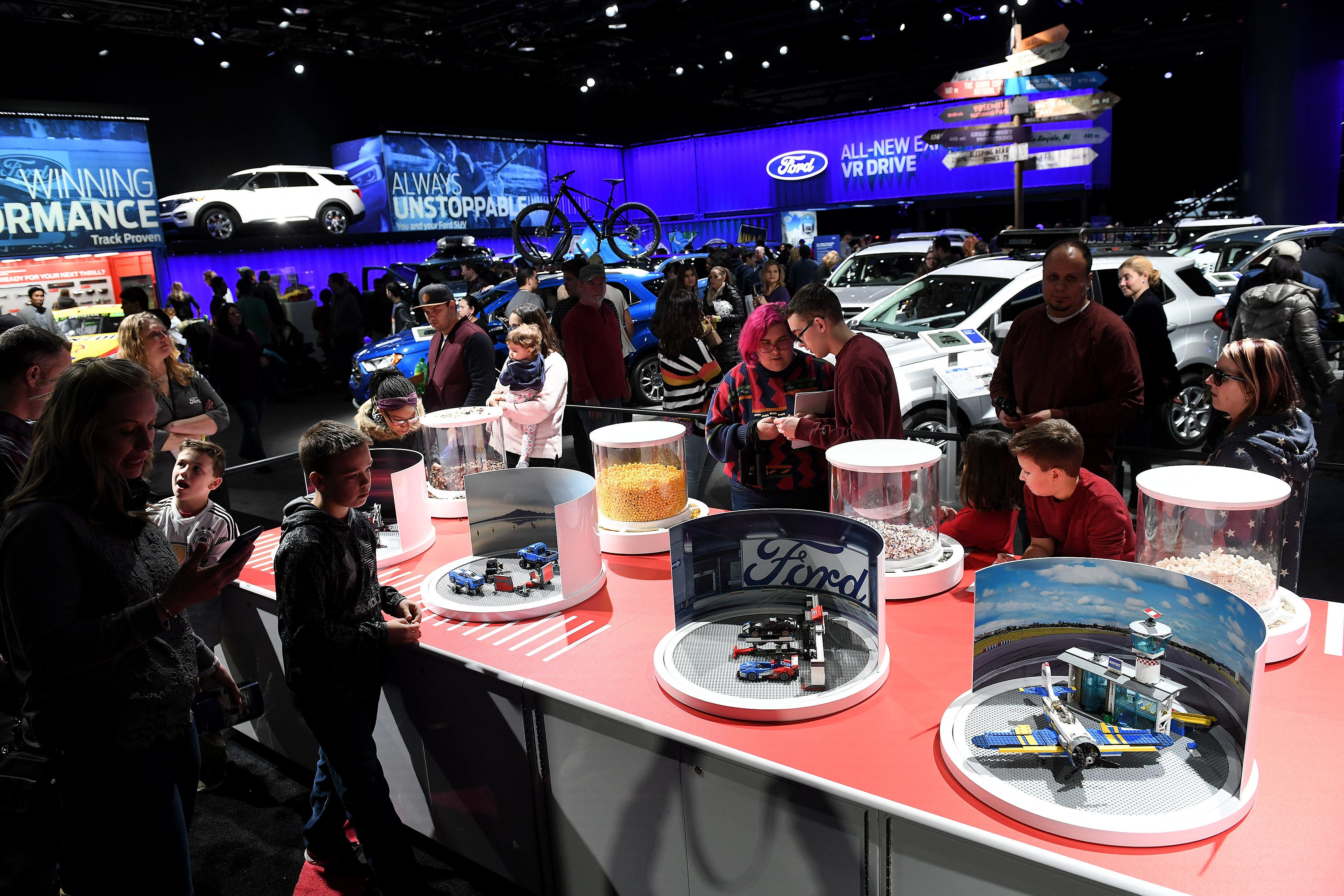 People can build Lego figures at the Ford display at the North American International Auto Show at Cobo Center in Detroit on Jan. 20, 2019.