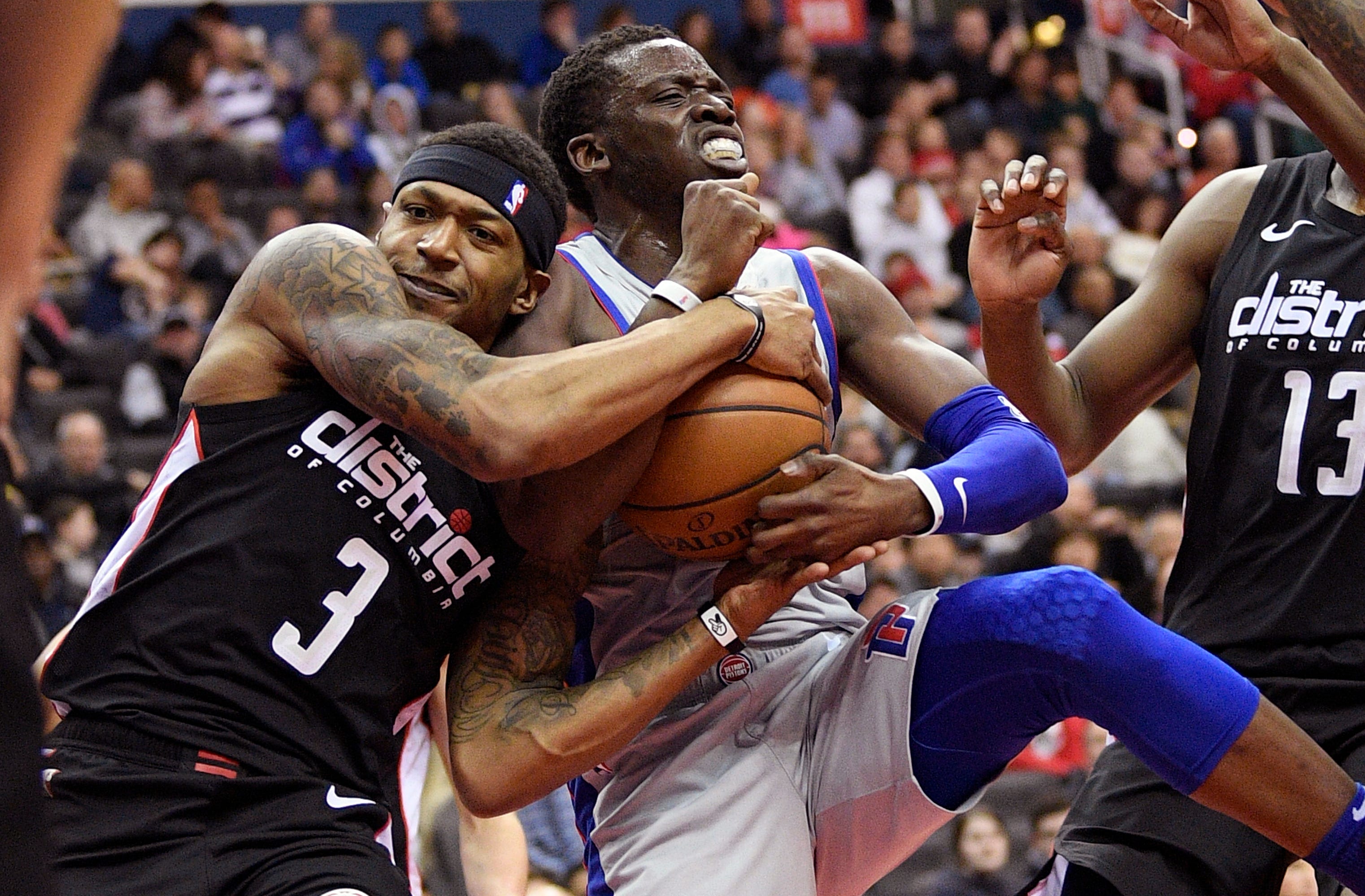 Wizards guard Bradley Beal (3) battles for the ball against Pistons guard Reggie Jackson during the first half.