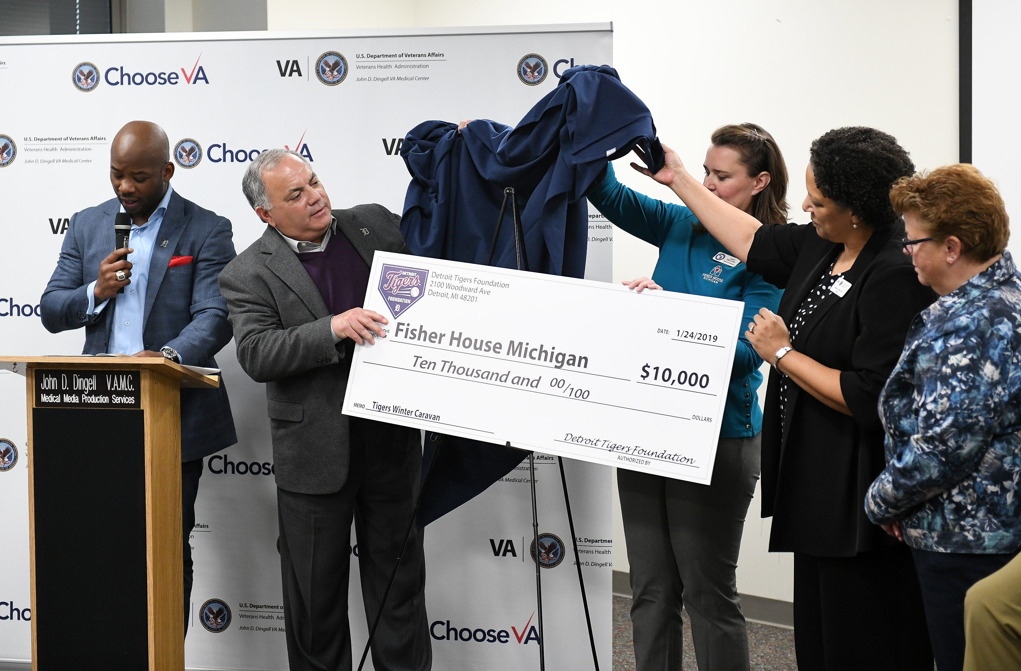 Tigers executive vice president of baseball operations and general manager Al Avila unveils a check towards the Fisher House which will be built near the VA Medical Center during a stop on the 2019 Detroit Tigers Winter Caravan at the John D. Dingell VA Medical Center in Detroit on Jan. 24, 2019.