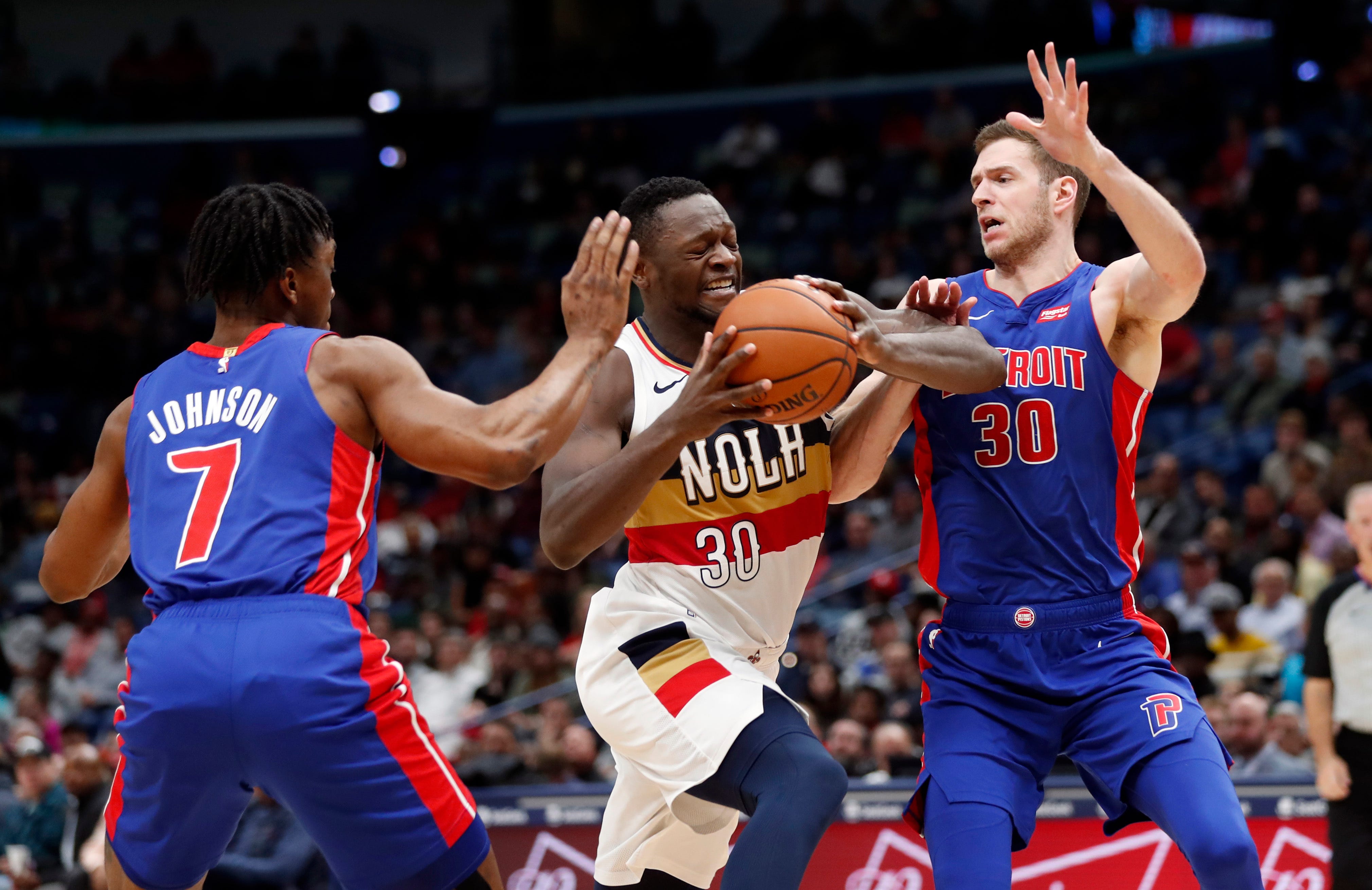New Orleans Pelicans center Julius Randle (30) drives to the basket between Detroit Pistons forward Stanley Johnson (7) and forward Jon Leuer (30) in the second half.