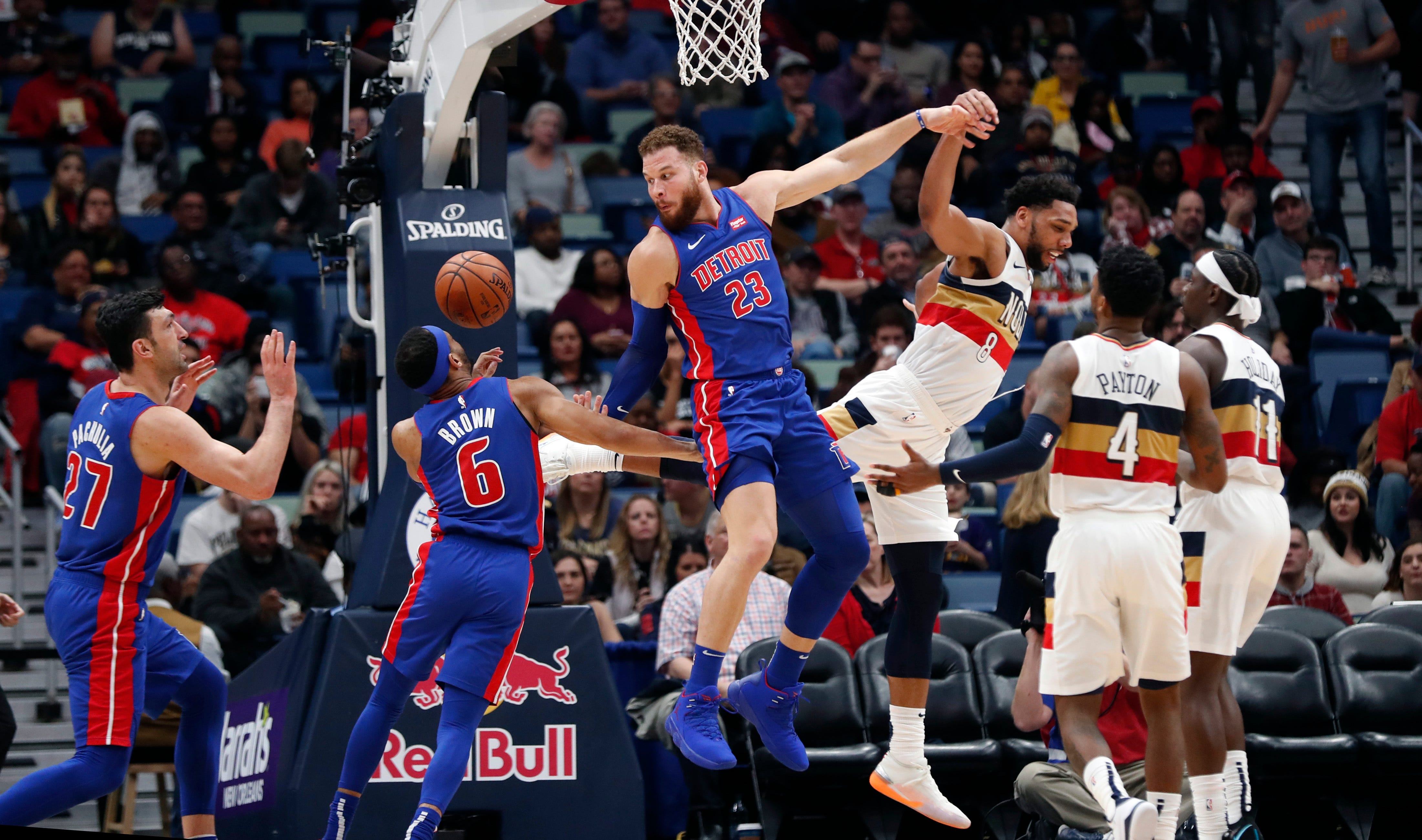 Detroit Pistons forward Blake Griffin (23) passes the ball to center Zaza Pachulia (27) as New Orleans Pelicans center Jahlil Okafor (8) defends during the 98-94 victory in New Orleans, Wednesday, Jan. 23, 2019.