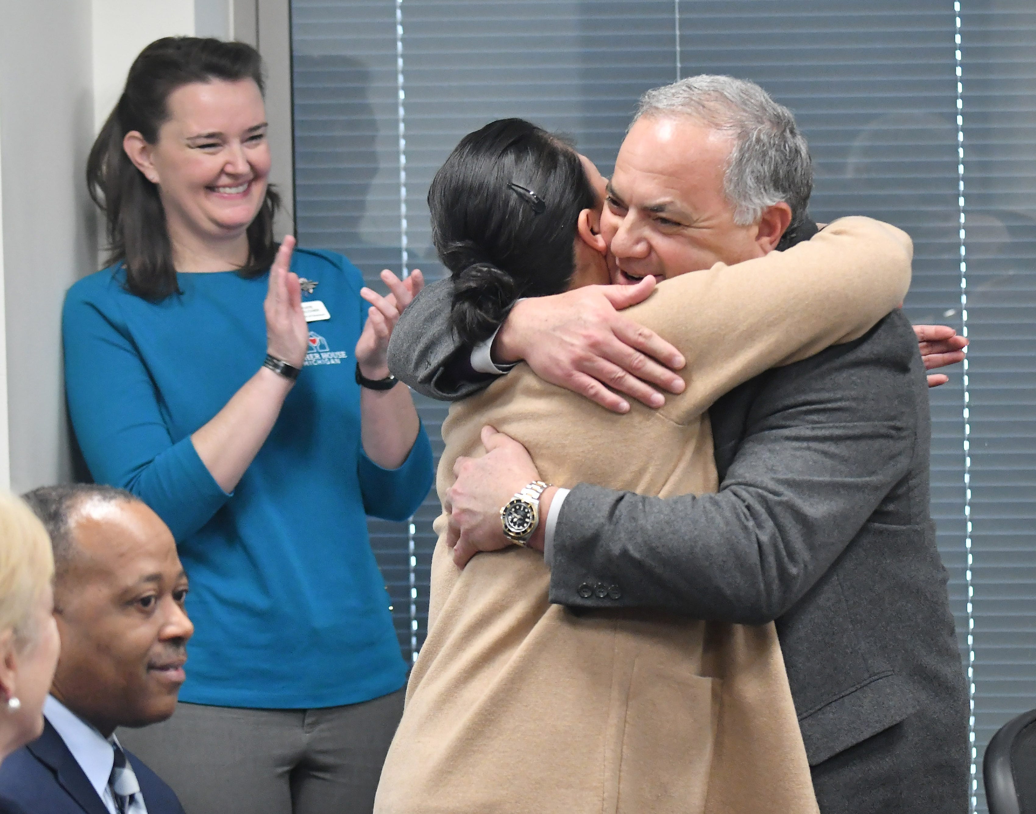 Tigers executive vice president of baseball operations and general manager Al Avila hugs Dorothy Narvaez-Woods, whose husband was killed in the line of duty serving as a Navy Seal, during a stop on the 2019 Detroit Tigers Winter Caravan at the John D. Dingell VA Medical Center in Detroit on Jan. 24, 2019. Narvaez-Woods spoke at the event and also served in the Navy.
