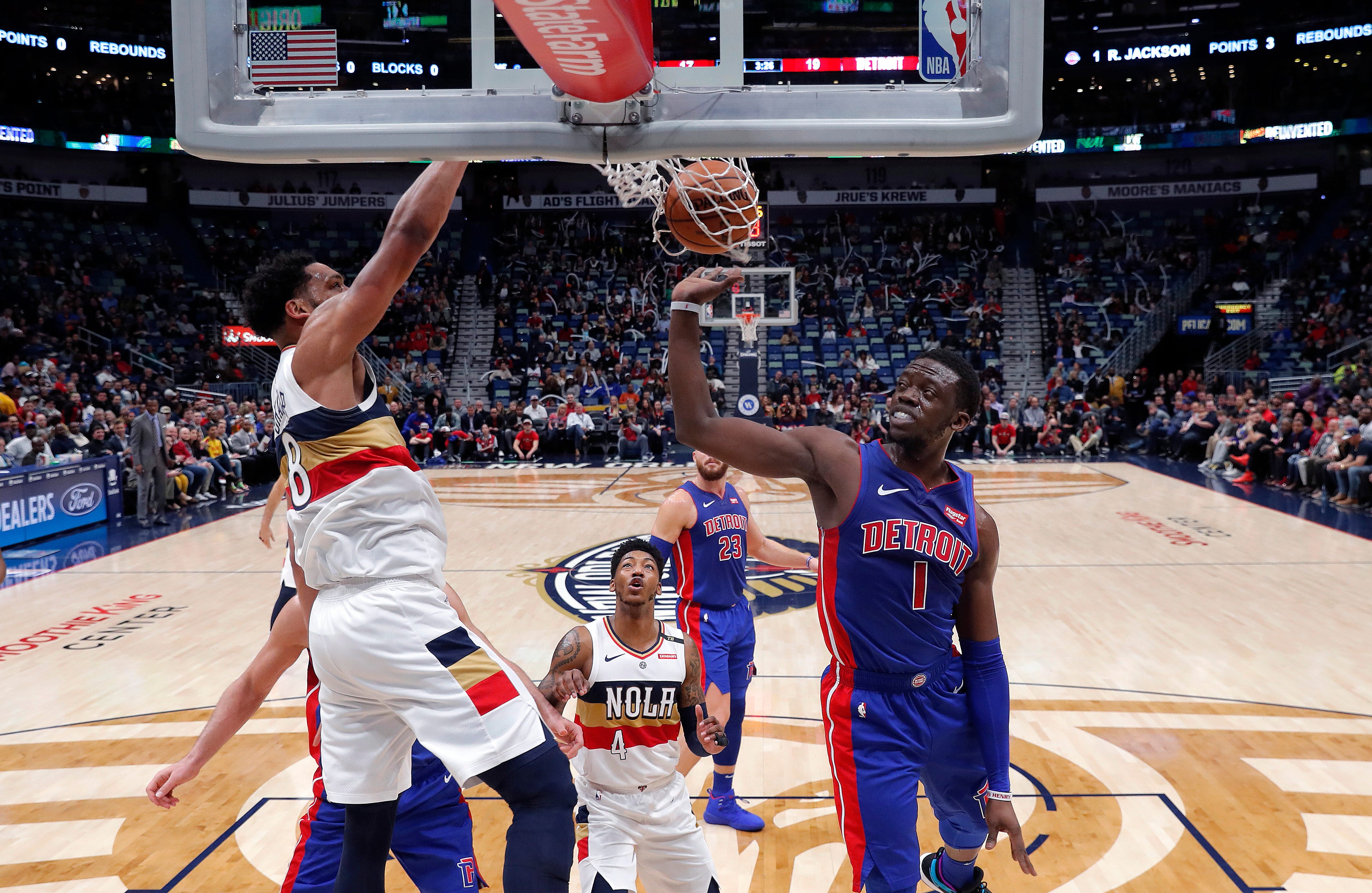 New Orleans Pelicans center Jahlil Okafor (8) slam dunks over Detroit Pistons guard Reggie Jackson (1) in the first half.