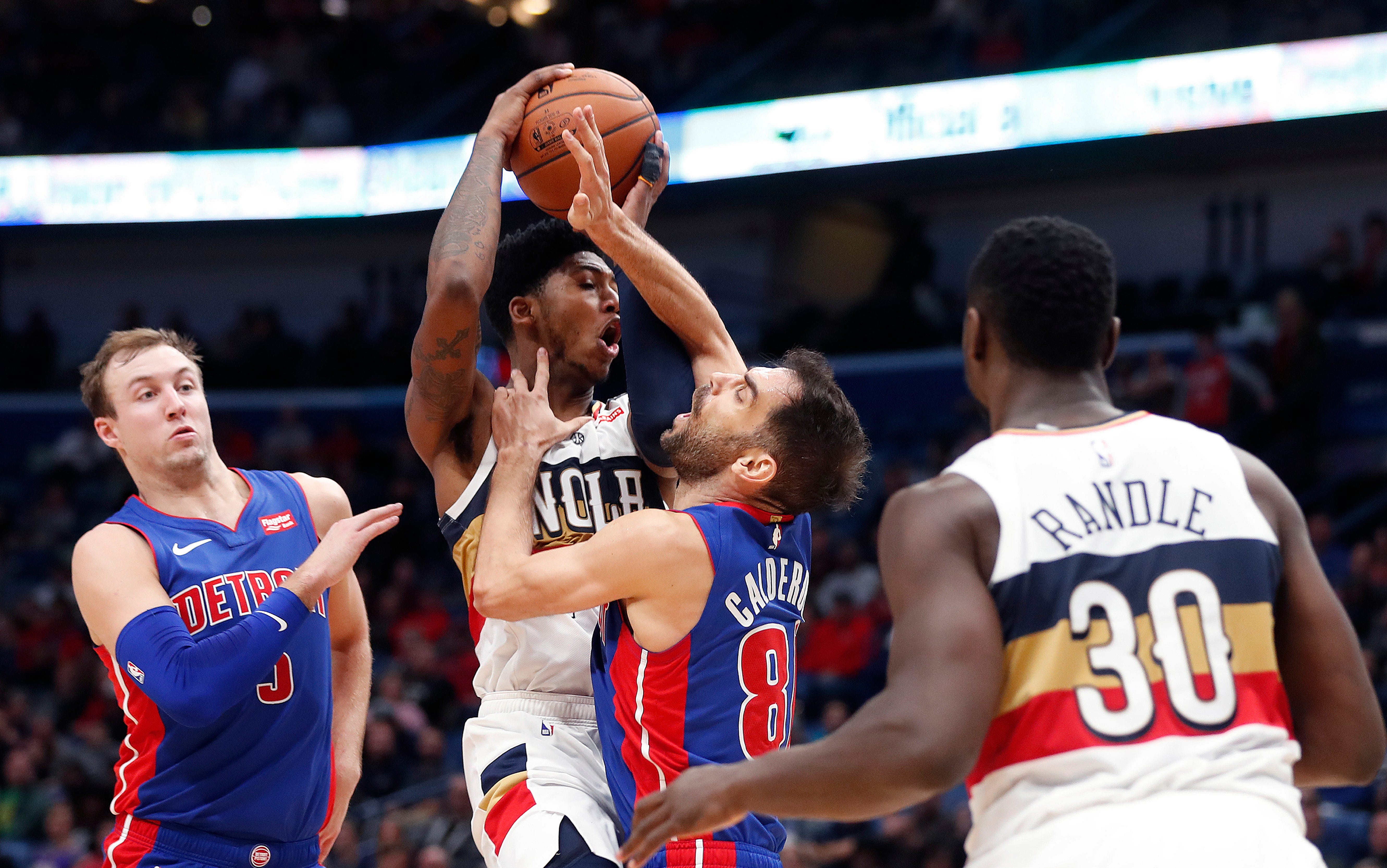 New Orleans Pelicans guard Elfrid Payton drives to the basket between Detroit Pistons guard Jose Calderon and guard Luke Kennard (5) in the second half.