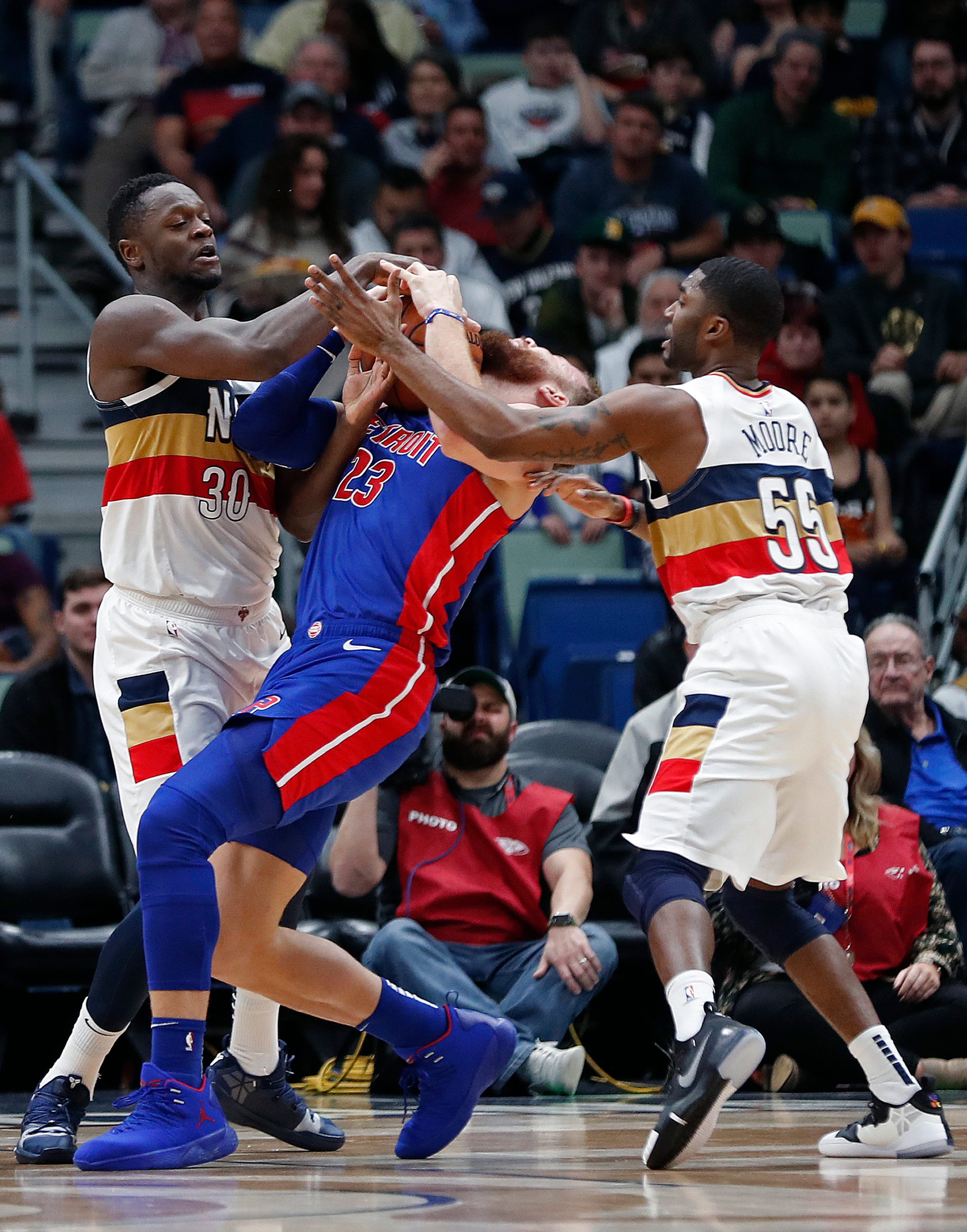 Detroit Pistons forward Blake Griffin (23) is double-teamed by New Orleans Pelicans center Julius Randle (30) and guard E'Twaun Moore (55) in the second half.
