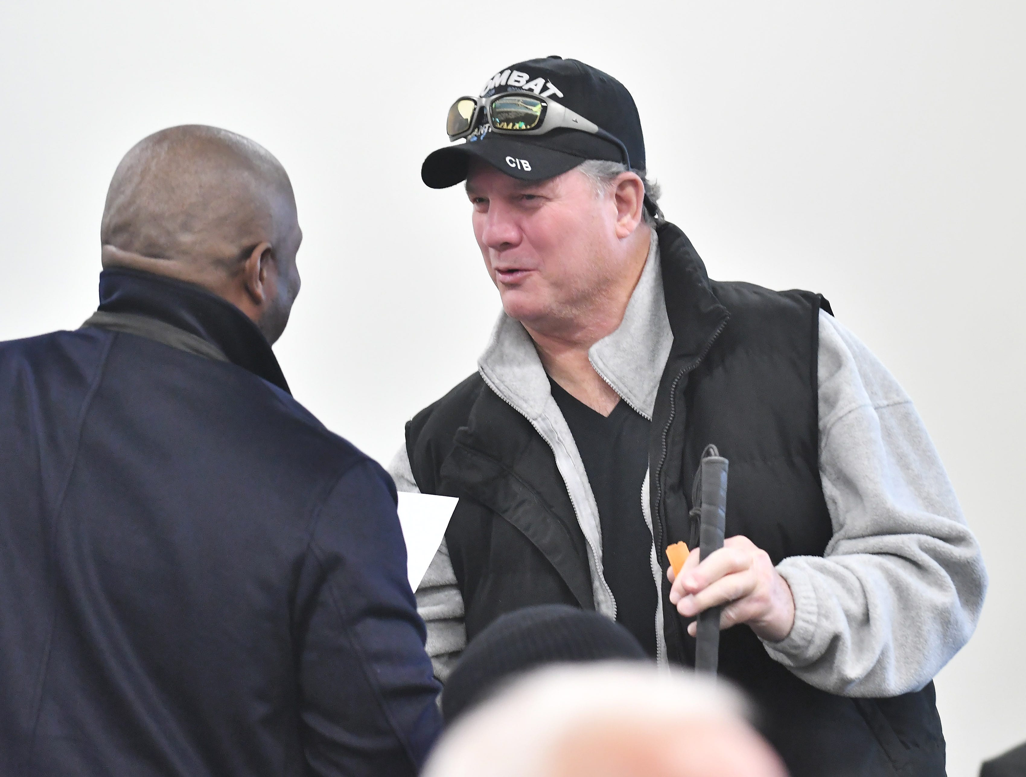 Tigers hitting coach Lloyd McClendon presents Vietnam combat veteran Charles Zimmer of Port Huron with some Tigers tickets during a stop on the 2019 Detroit Tigers Winter Caravan at the John D. Dingell VA Medical Center in Detroit on Jan. 24, 2019.