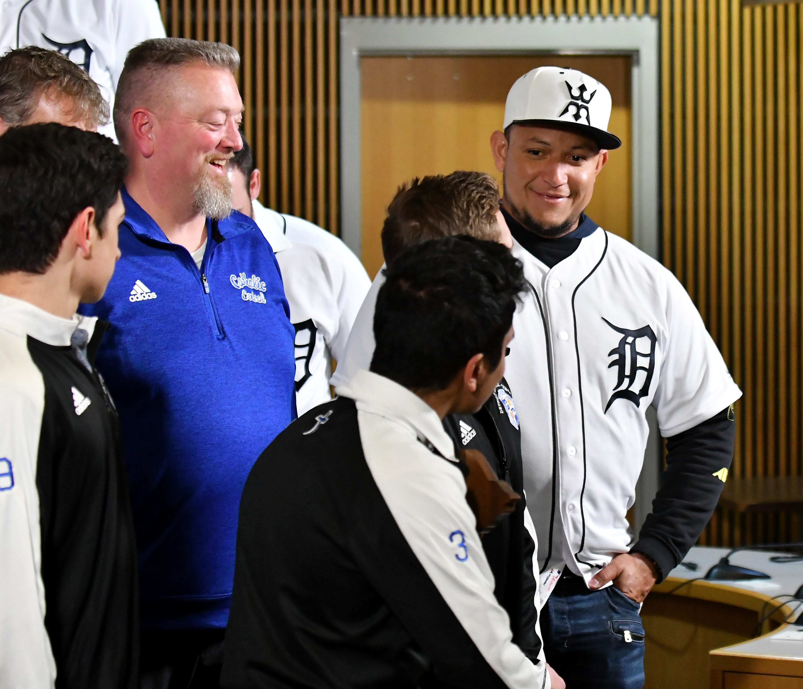 Tigers ' Miguel Cabrera jokes around with one of the members of the Div. 1 champion Novi soccer players, Ryan Pierson, after they take a group photo during a stop on the 2019 Detroit Tigers Winter Caravan at the Novi Civic Center in Novi, Mich., on Jan. 24, 2019.