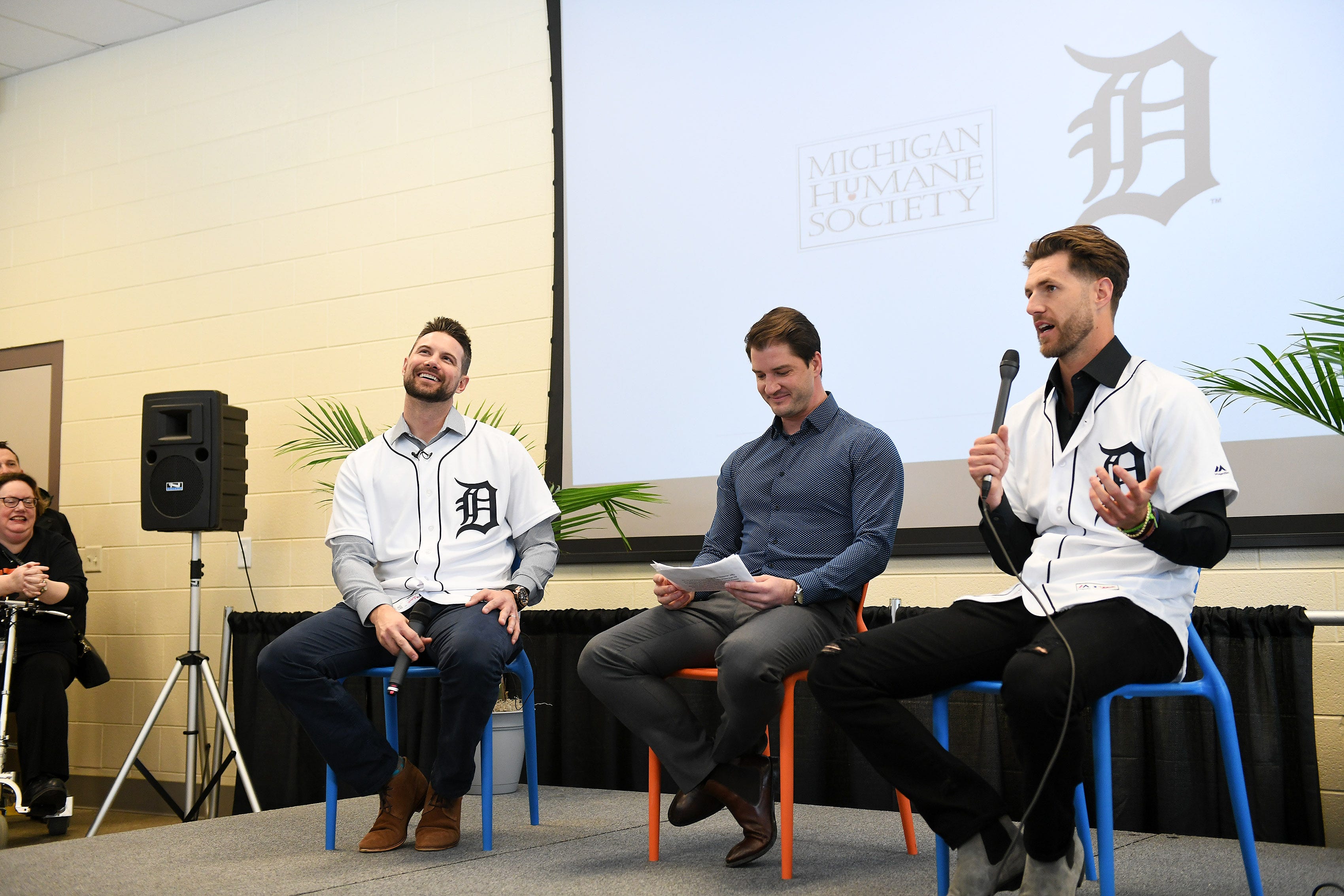 Tigers' Jordy Mercer, left, and Shane Greene, right, answer questions from the people gathered, moderated by Johnny Kane from Fox Sports Detroit, center, at the Michigan Humane Society.