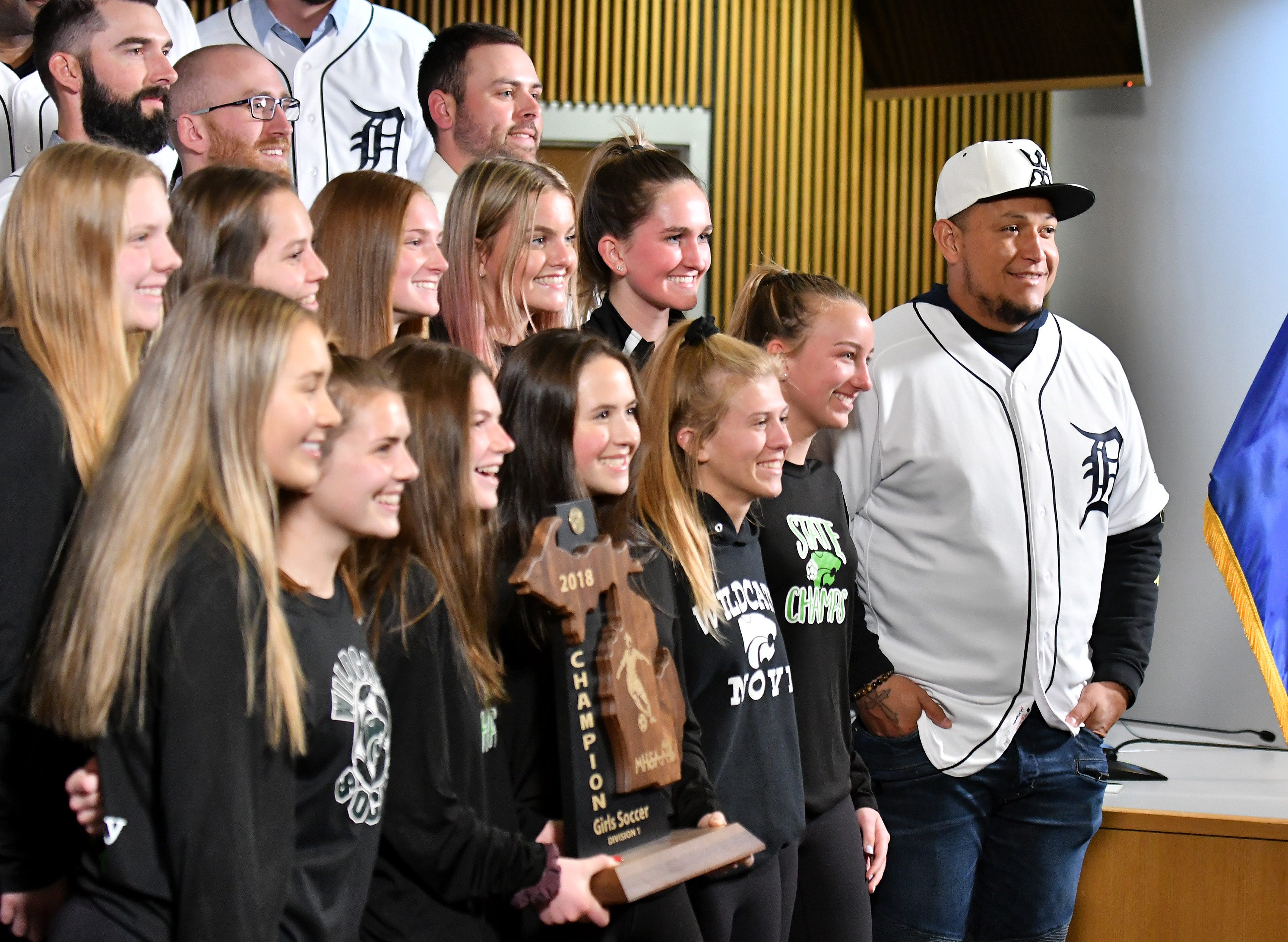 Tigers ' Miguel Cabrera, right, and members of the Detroit Tigers take a group photo with some of the Div. 1 champion Novi girls soccer players at the Novi Civic Center.