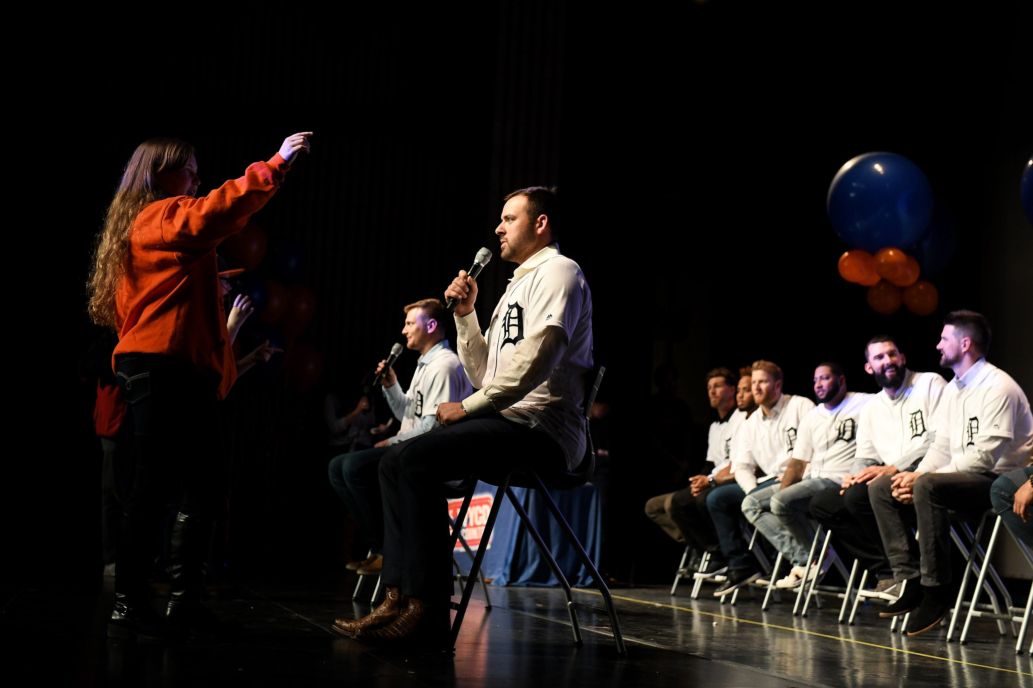 Lorna Davis, 15, of Carelton, left, gives clues to Tigers pitcher Michael Fulmer while they play a charades type game at a kids rally at Novi High School.
