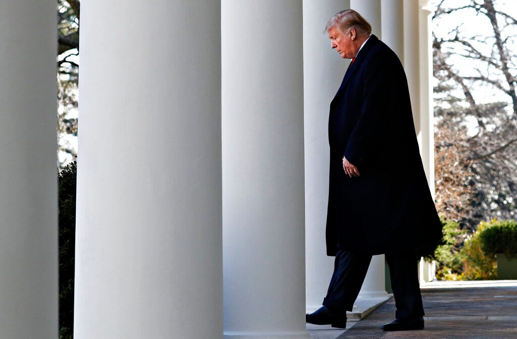 President Donald Trump walks through the colonnade of the White House on arrival to announce a deal to temporarily reopen the government, Friday, Jan. 25, 2019, from the Rose Garden of the White House in Washington.