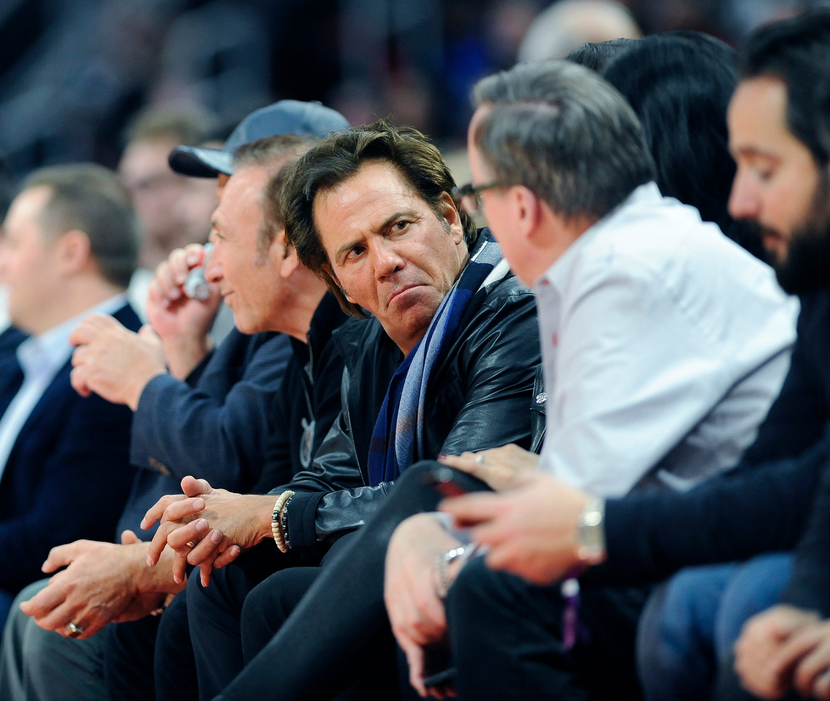 Pistons' owner Tom Gores, center, chats with a fan in the first quarter.