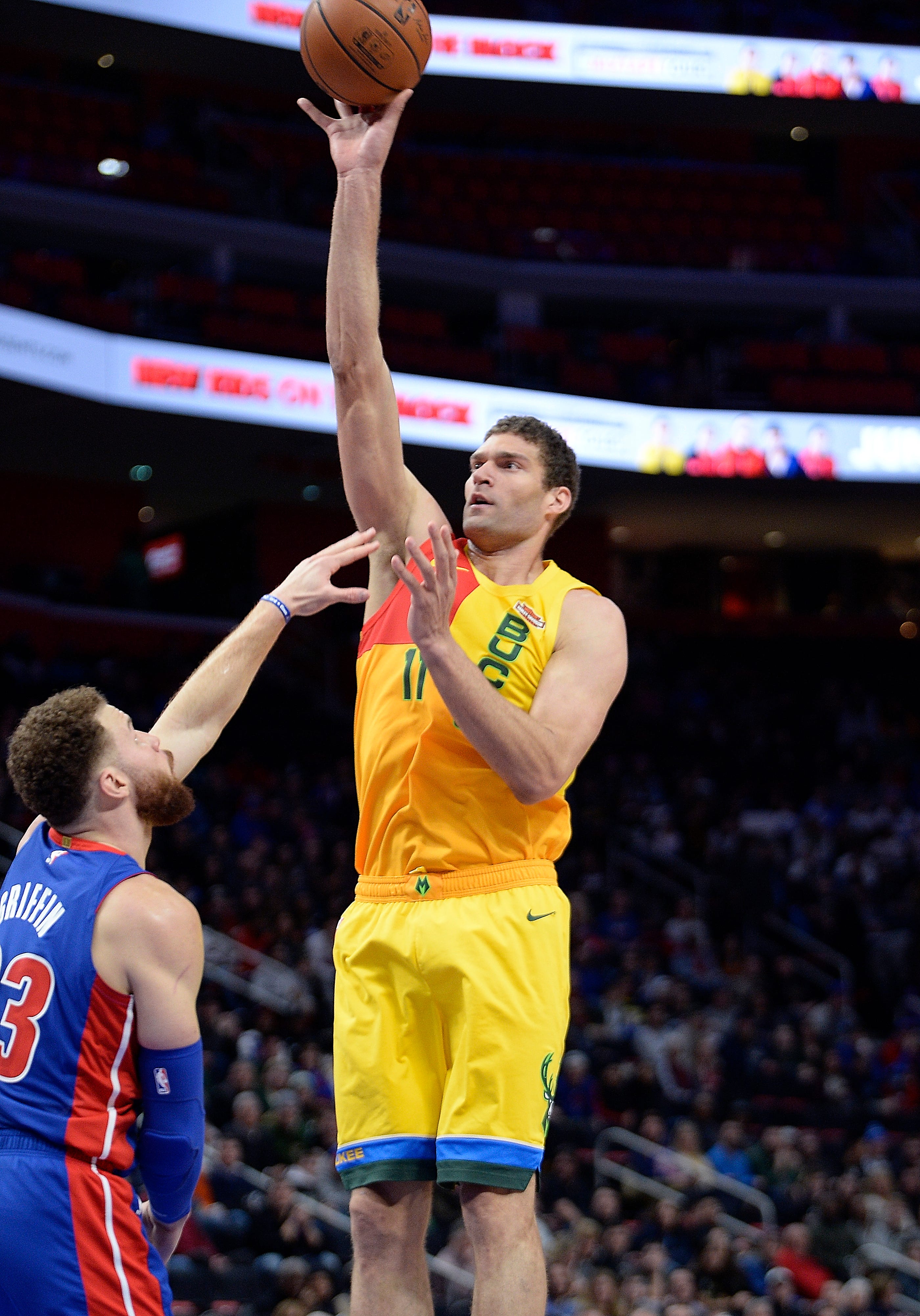 Bucks' Brook Lopez scores over Pistons' Blake Griffin in the first quarter.