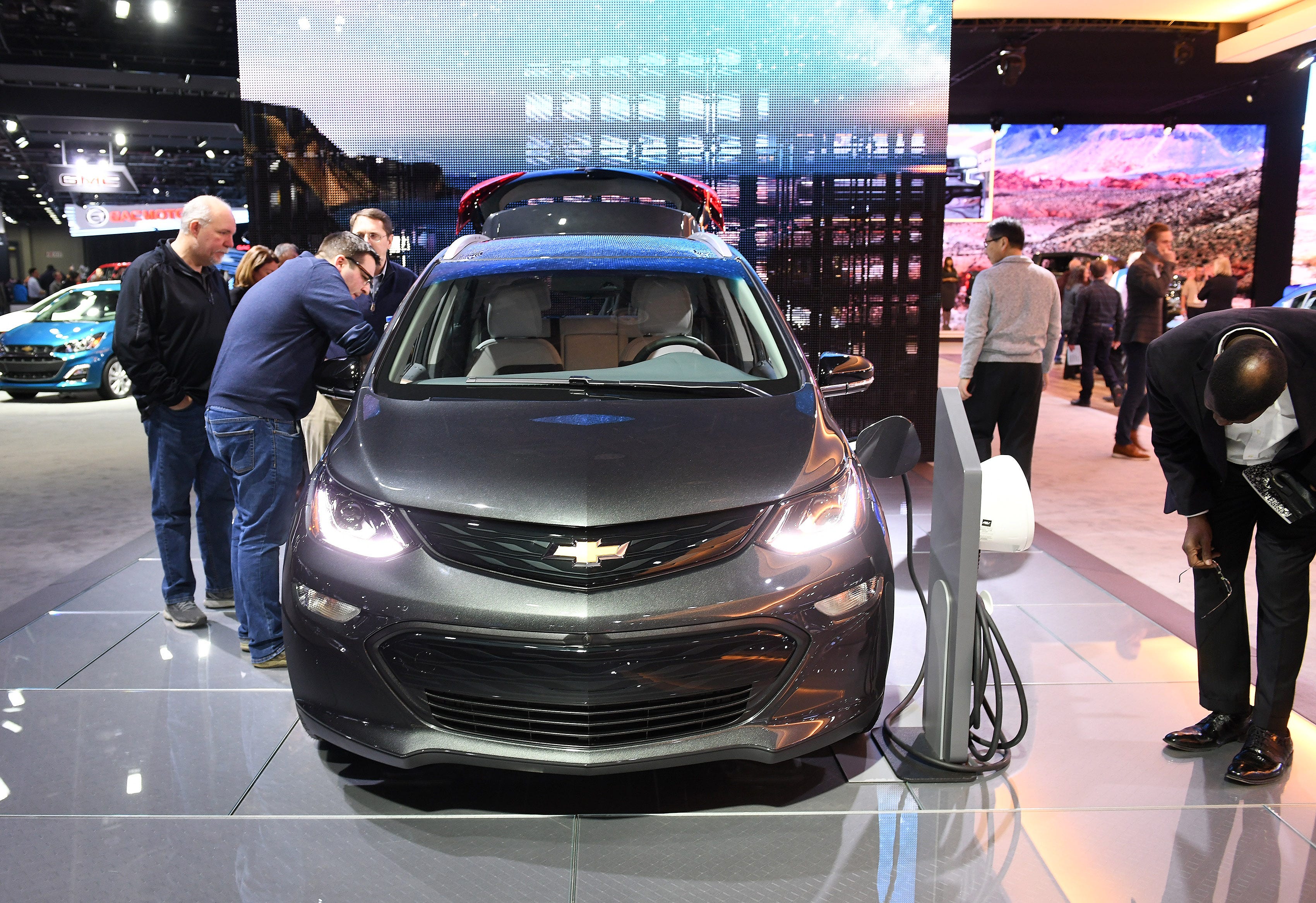 People check out the 2019 Chevrolet Bolt EV at the North American International Auto Show at Cobo Center in Detroit on Jan. 17, 2019.