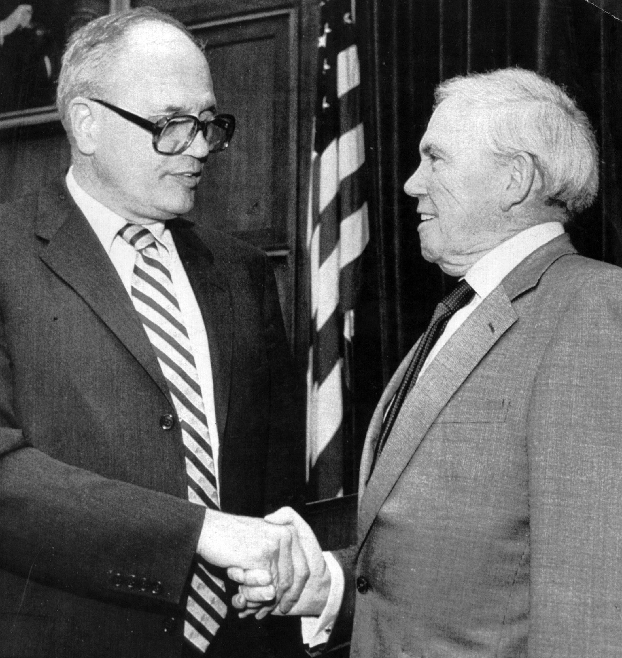 United Auto Workers president Douglas Fraser, right, shakes hands with Rep. John Dingell, chairman of the House Committee on Energy and Commerce, prior to a hearing Jan. 24, 1983 on the loss of health benefits due to unemployment.