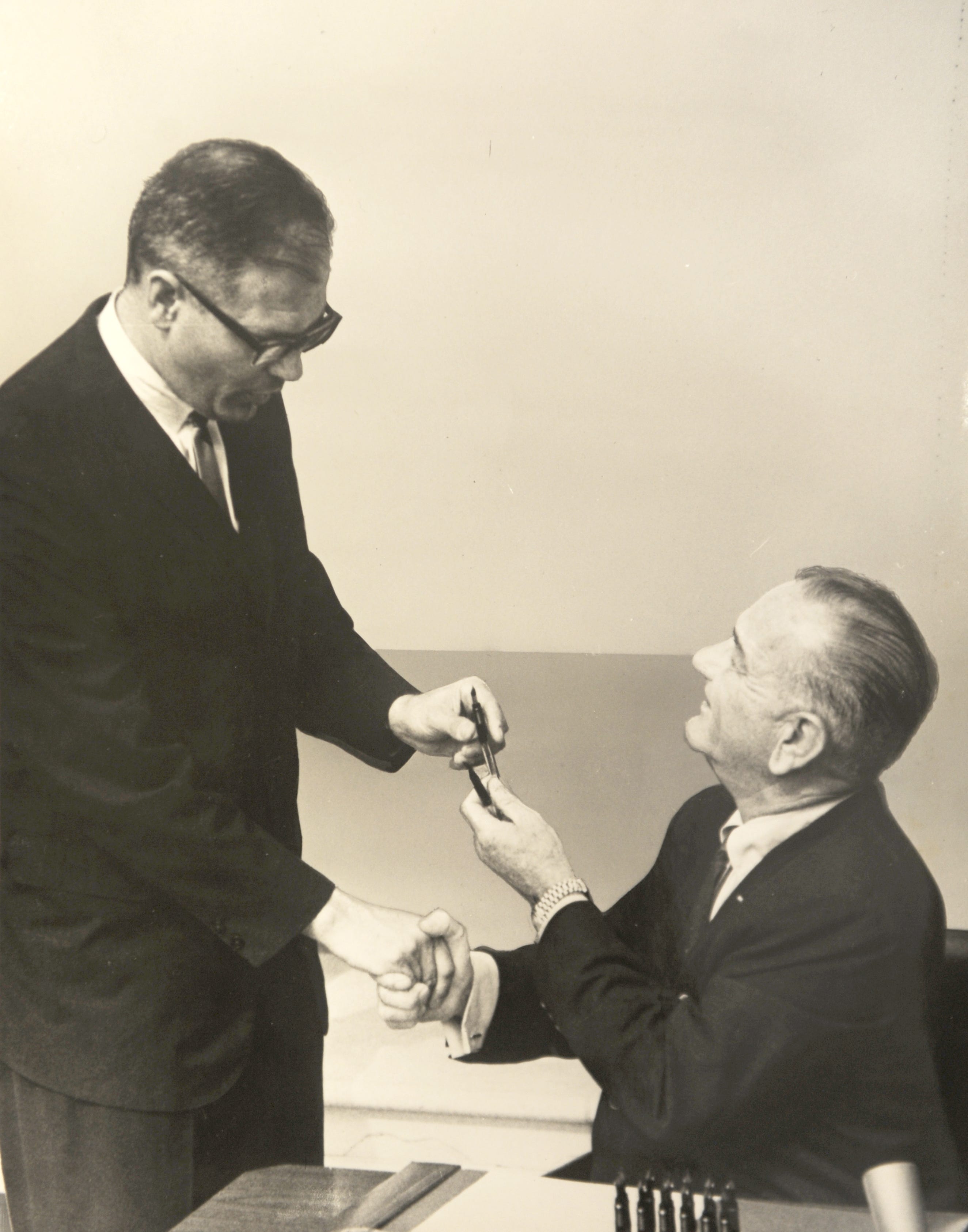 Dingell kept a personal and professional photo archive in his office, including this photo of President Lyndon Johnson handing him a pen after signing a bill.