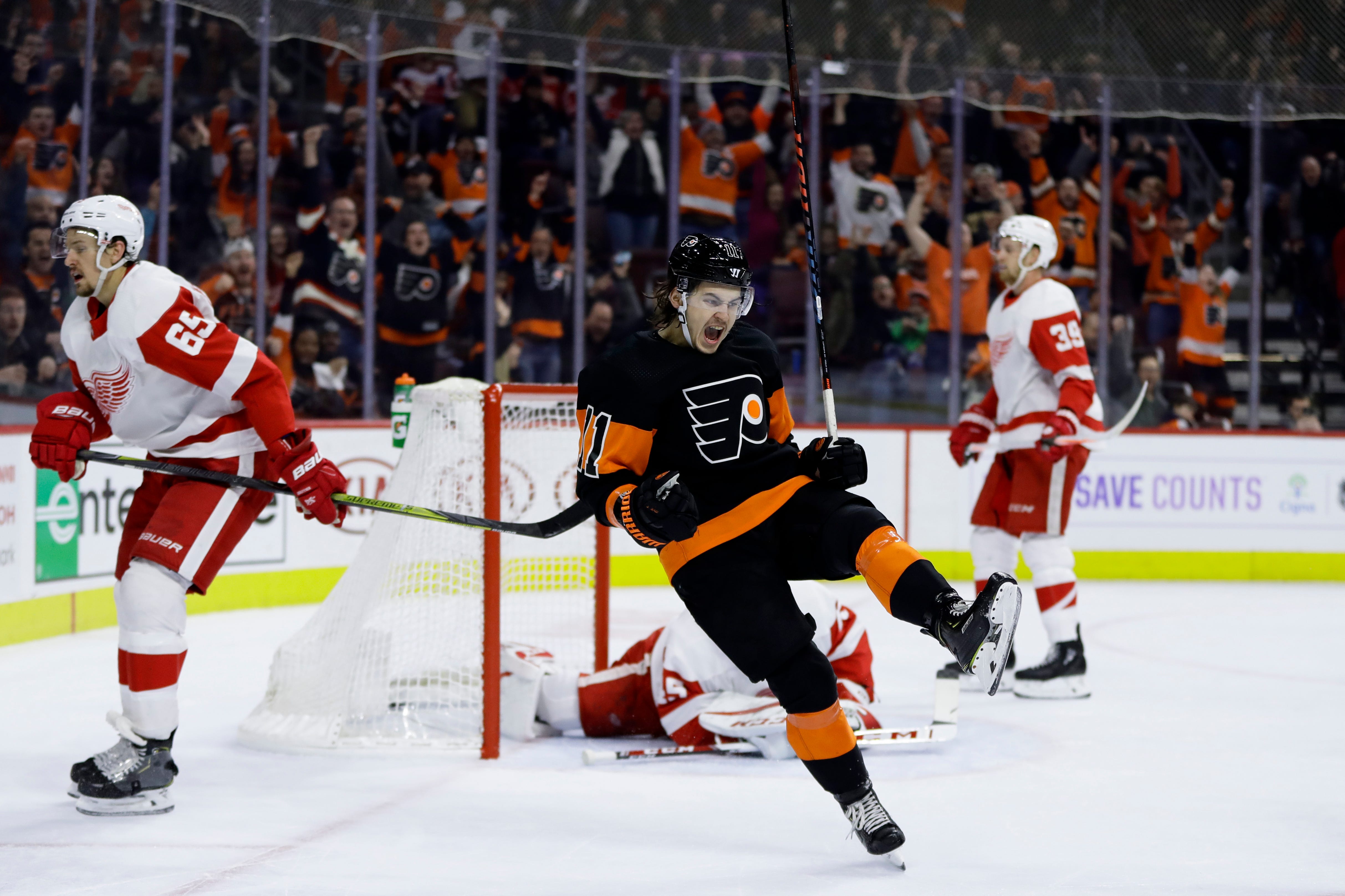 Philadelphia Flyers' Travis Konecny (11) celebrates after scoring the game-winning goal during overtime Saturday. The Flyers defeated the Red Wings 6-5.