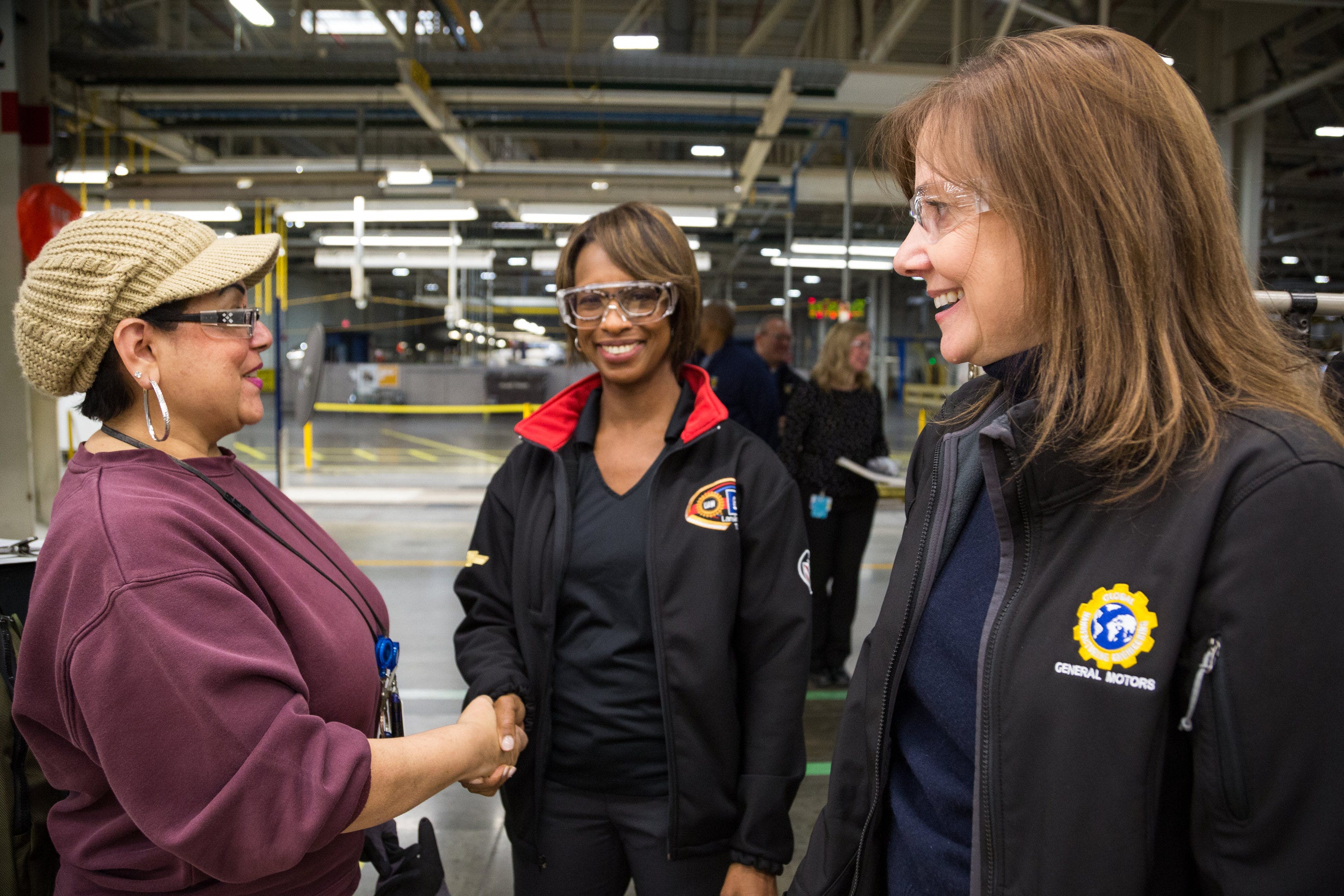 General Motors Executive Vice President Global Manufacturing Alicia Boler Davis, center, and GM Chairman and CEO Mary Barra, right, talk with employees Monday on a tour of GM Lansing Delta Township Assembly in Lansing. Barra announced  GM is investing $36 million at the plant for future crossover production.