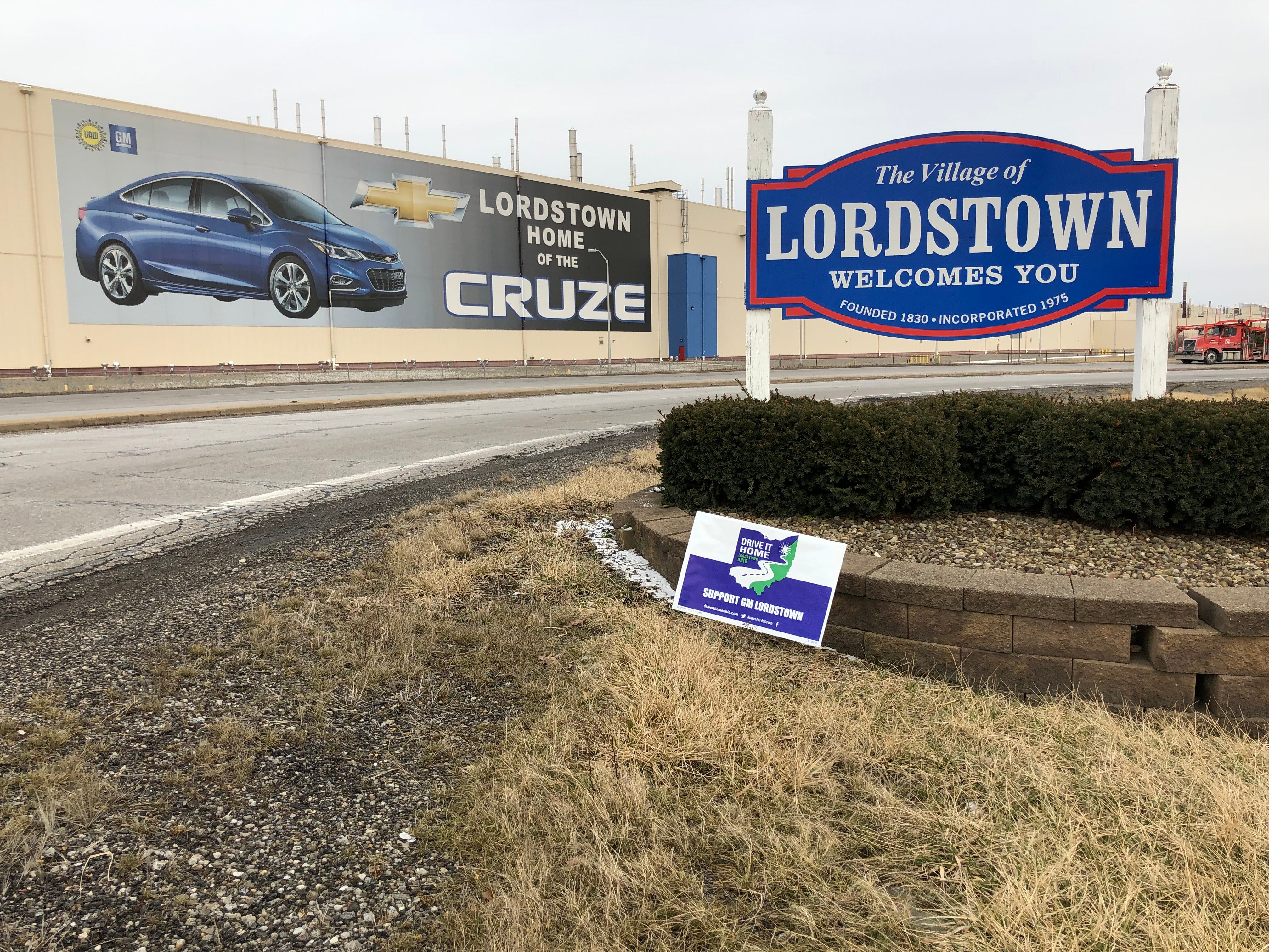 A sign in front of General Motors Co.’s Lordstown Assembly Plant welcomes drivers exiting the Ohio Turnpike in Lordstown, accompanied by a Drive it Home yard sign. Photographed Feb. 19, 2019.