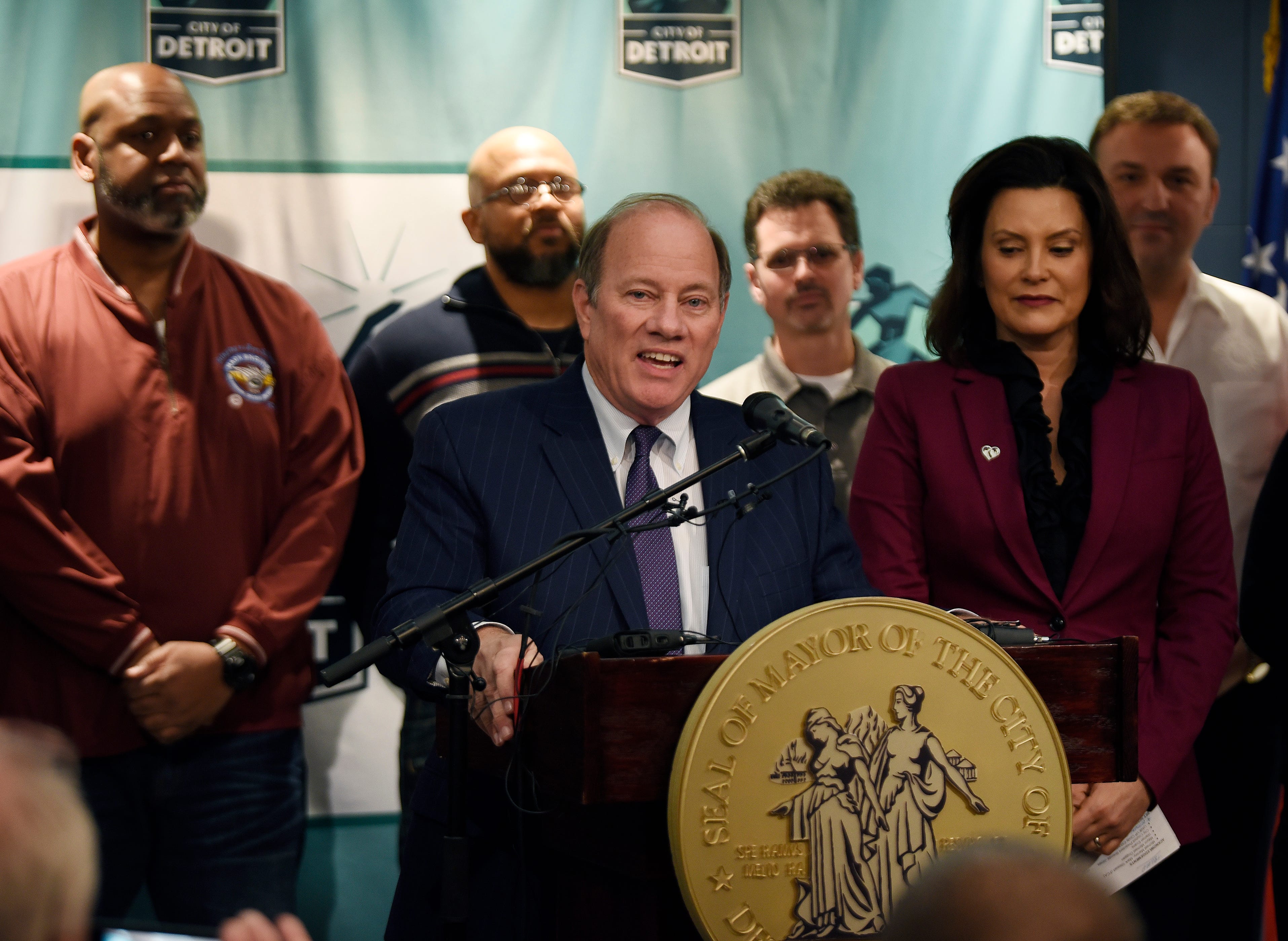 Detroit Mayor Mike Duggan (center), along with Michigan Gov. Gretchen Whitmer (right)  and several FCA employees announce that FCA will be building a new assembly plant in Detroit.