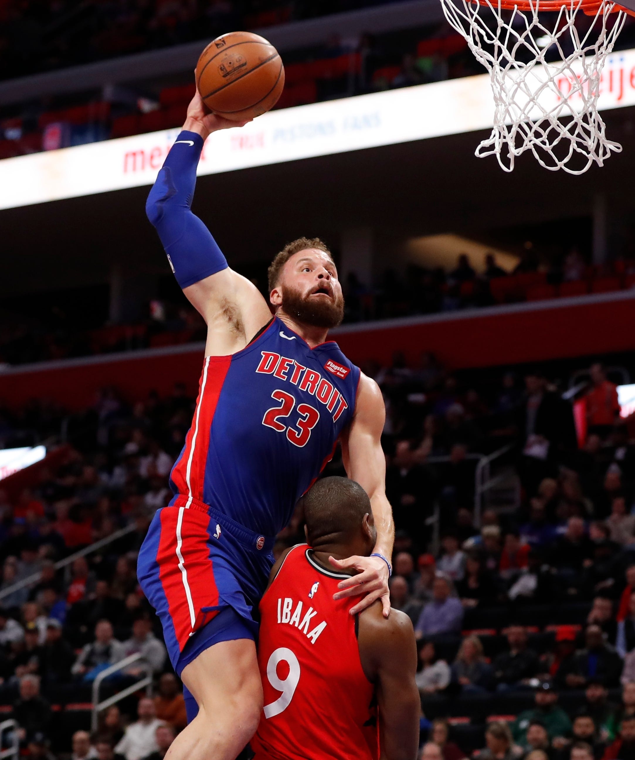 Detroit Pistons forward Blake Griffin (23) goes for a dunk over Toronto Raptors center Serge Ibaka (9) during the first half of an NBA basketball game, Sunday, March 3, 2019, in Detroit.